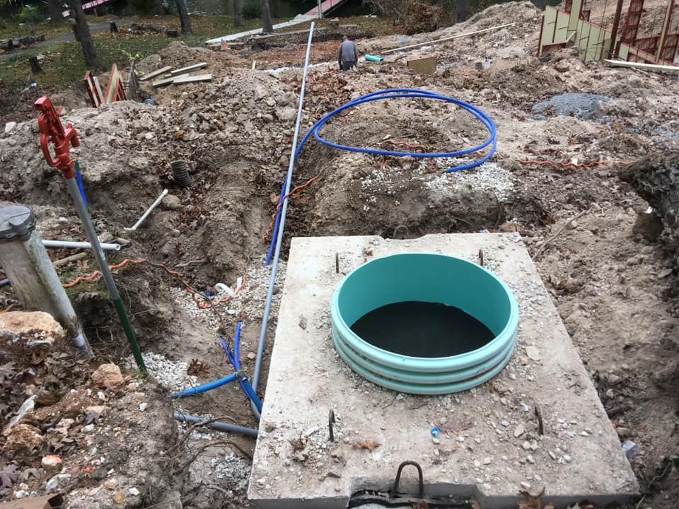 A septic tank is being installed in a dirt field | Eldon, MO | Beanland Well Drilling & Pump Service