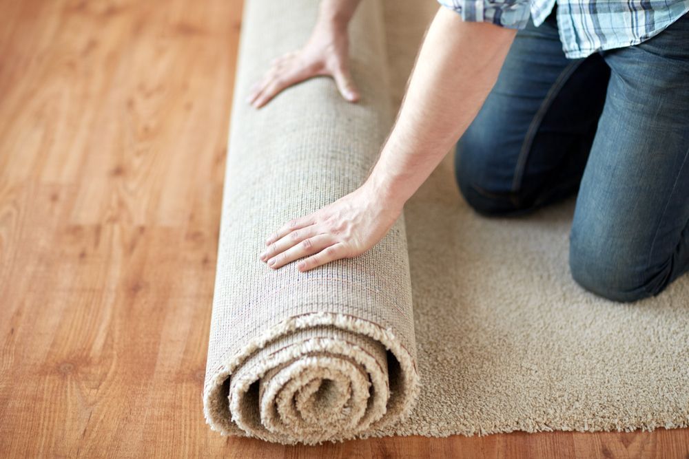 A Person Rolling Up A Rug — Citrus Clean Central Coast In Terrigal, NSW