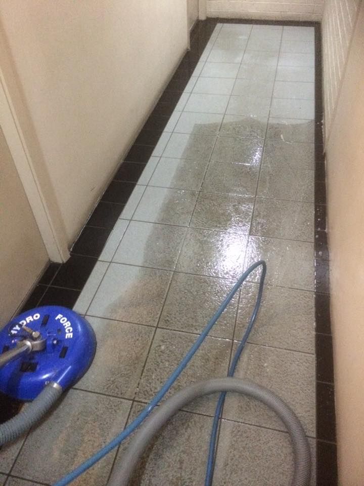 A Person Is Cleaning A Rug With A Vacuum Cleaner — Citrus Clean Central Coast In Lake Haven, NSW