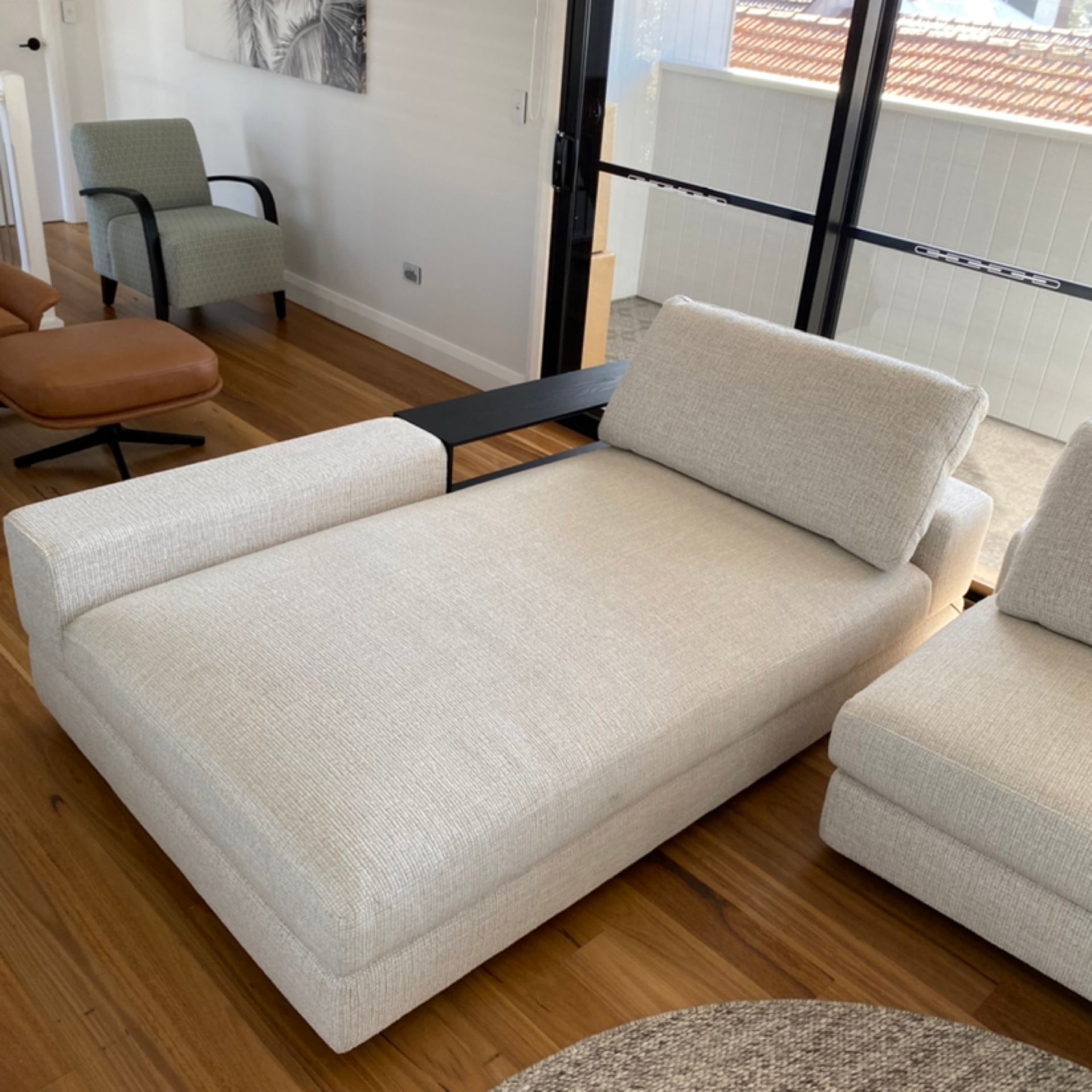 A Person Is Cleaning A Couch With A Vacuum Cleaner — Citrus Clean Central Coast In Lake Haven, NSW