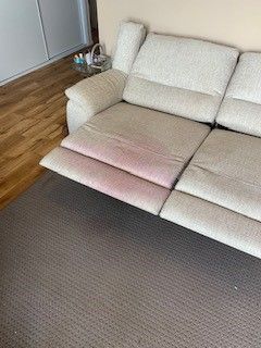 A Person Is Using A Vacuum Cleaner To Clean A Bed — Citrus Clean Central Coast In Lake Haven, NSW