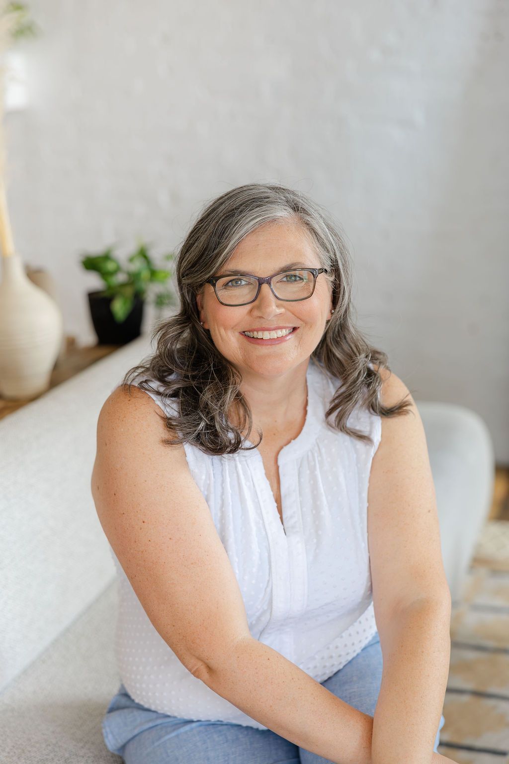 Diane leaning on a railing with with Positano in the background