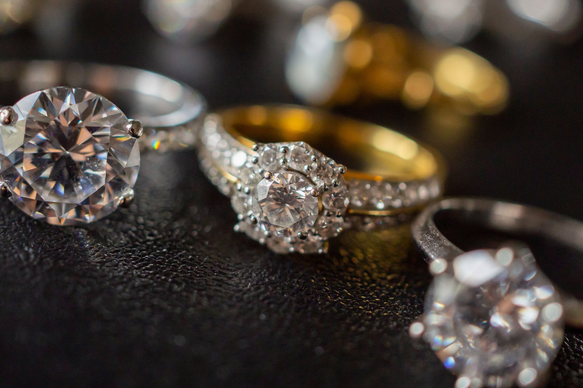 Elegant diamond jewelry rings against a black backdrop, close-up. Elegant diamond jewelry rings against a black backdrop, close-up.