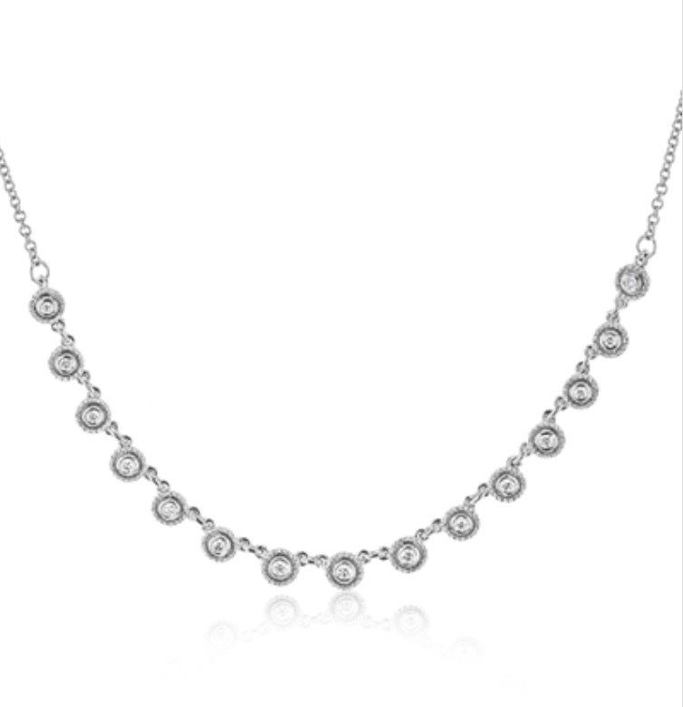 Silver necklace with circular diamond pendants along the chain.