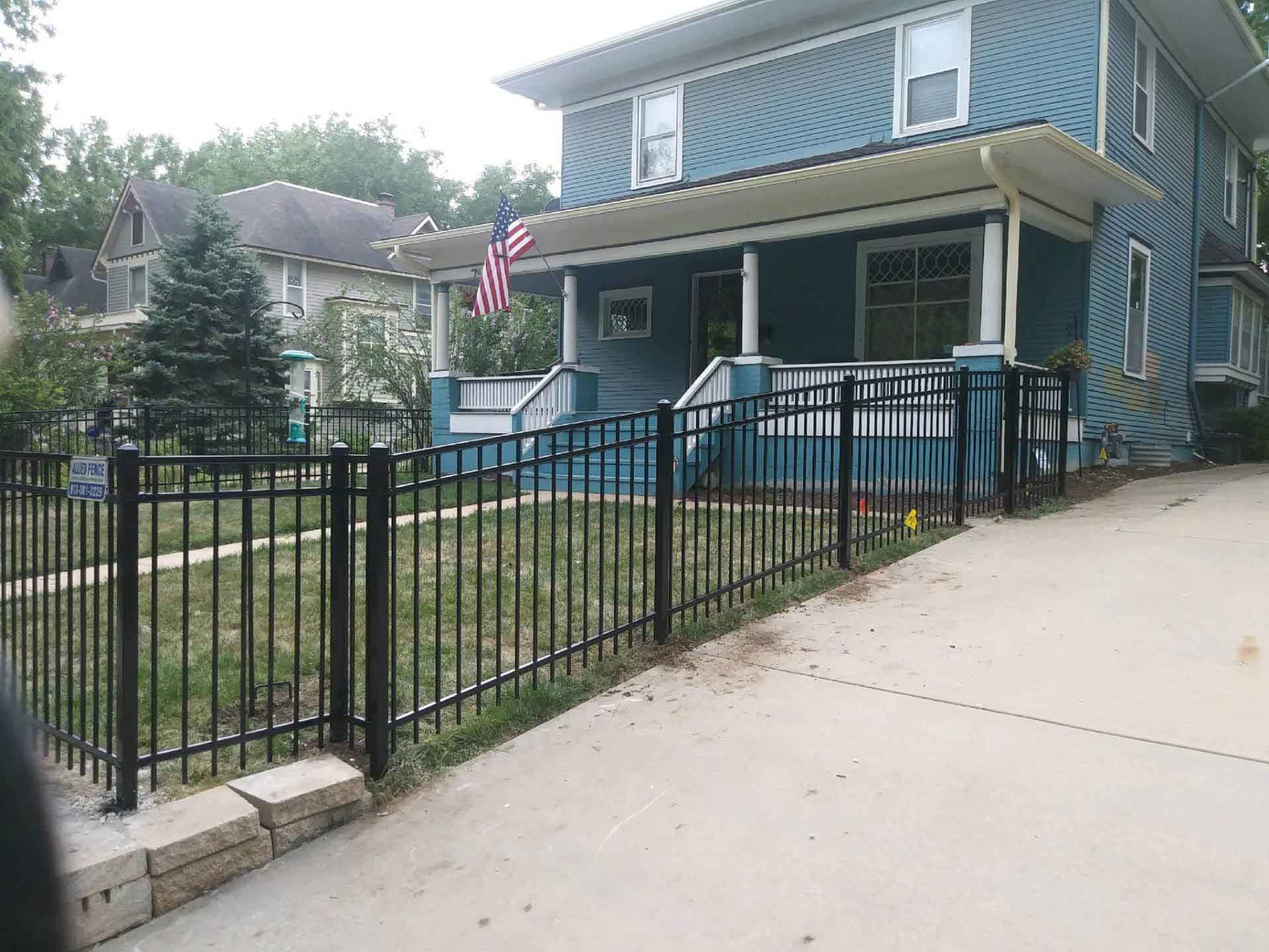 Fence Around the House with American Flag — Kansas City, KS — Allied Fence & Security
