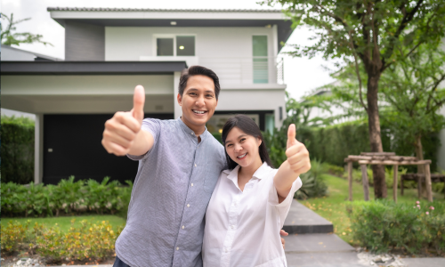 Satisfied homeowner relaxing in their beautifully landscaped yard with Mid-Tenn dumpster visible in background