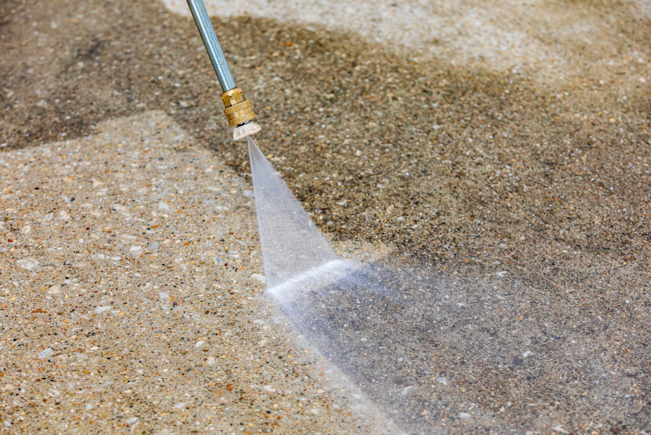 Asphalt patio being pressure washed