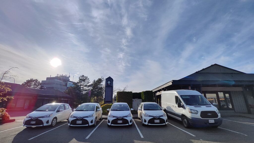 HB Cleaning Solutions work vans parked together in a parking lot