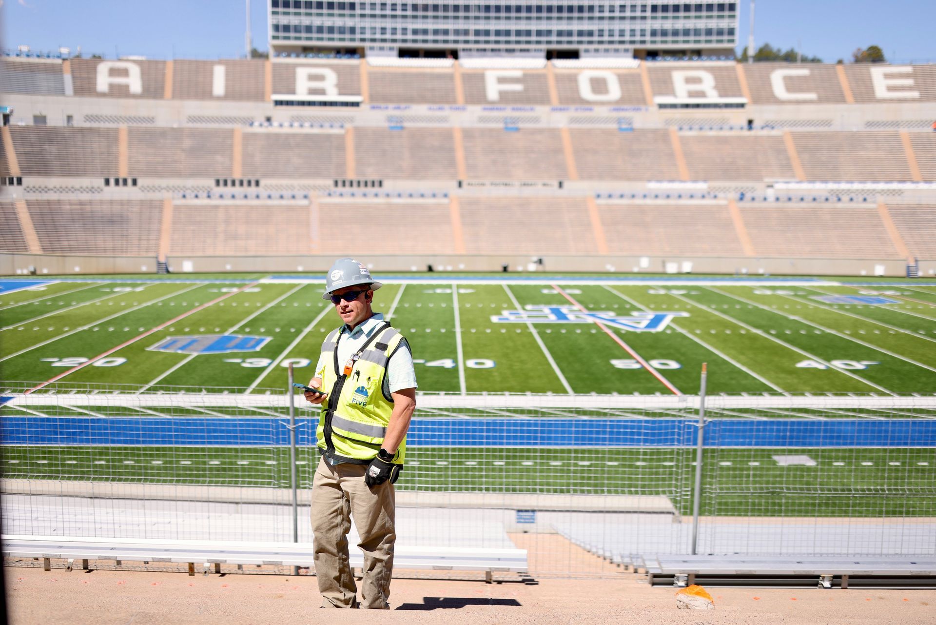 Construction worker standing in front of newly built Air Force Academy field