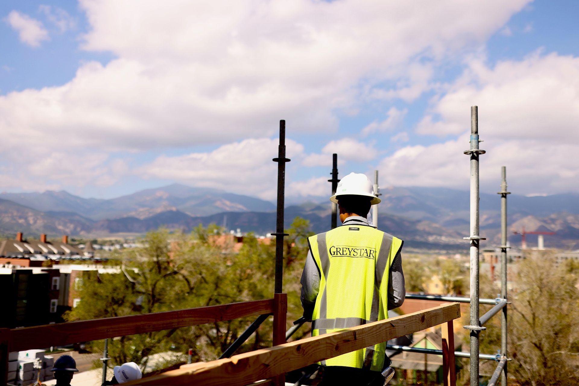 Construction worker looking out over the foothills of Colorado Springs