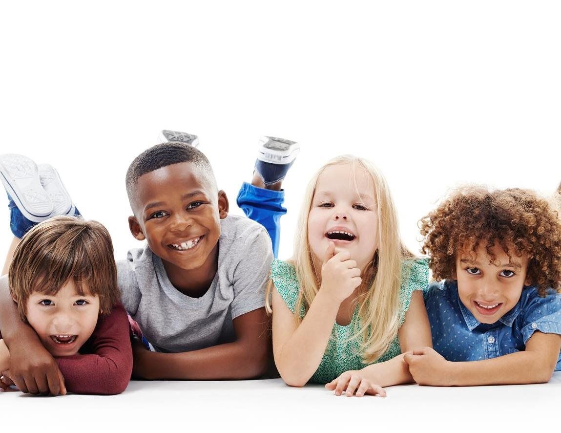 Kids smiling on while laying on the ground