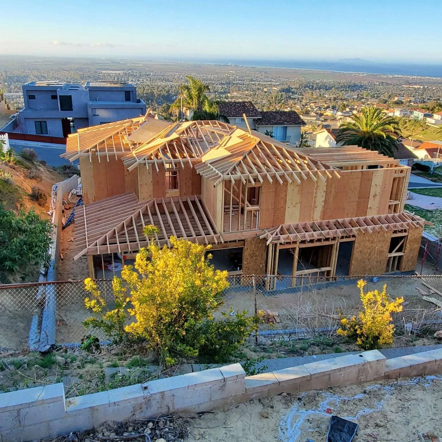 An aerial view of a house under construction on a hillside