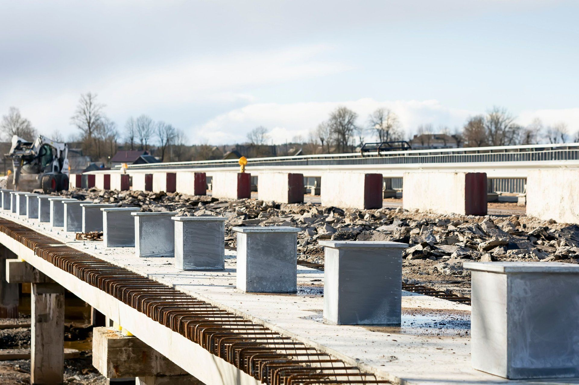 A row of concrete blocks are sitting on top of a bridge under construction.
