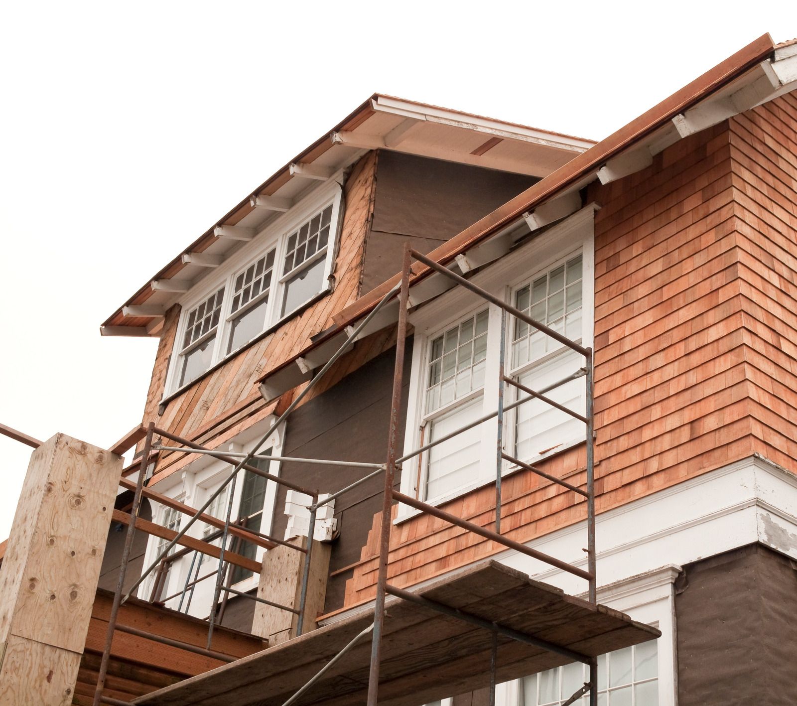 A brick building under construction with scaffolding around it