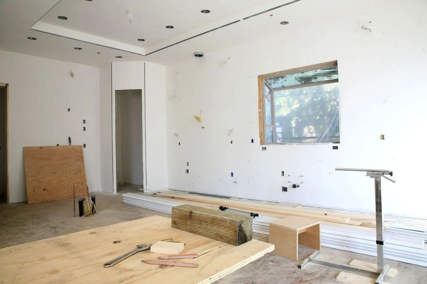 An empty room with a wooden table and a window