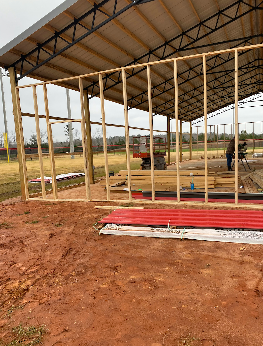 A building is being built with wooden frames and a roof.