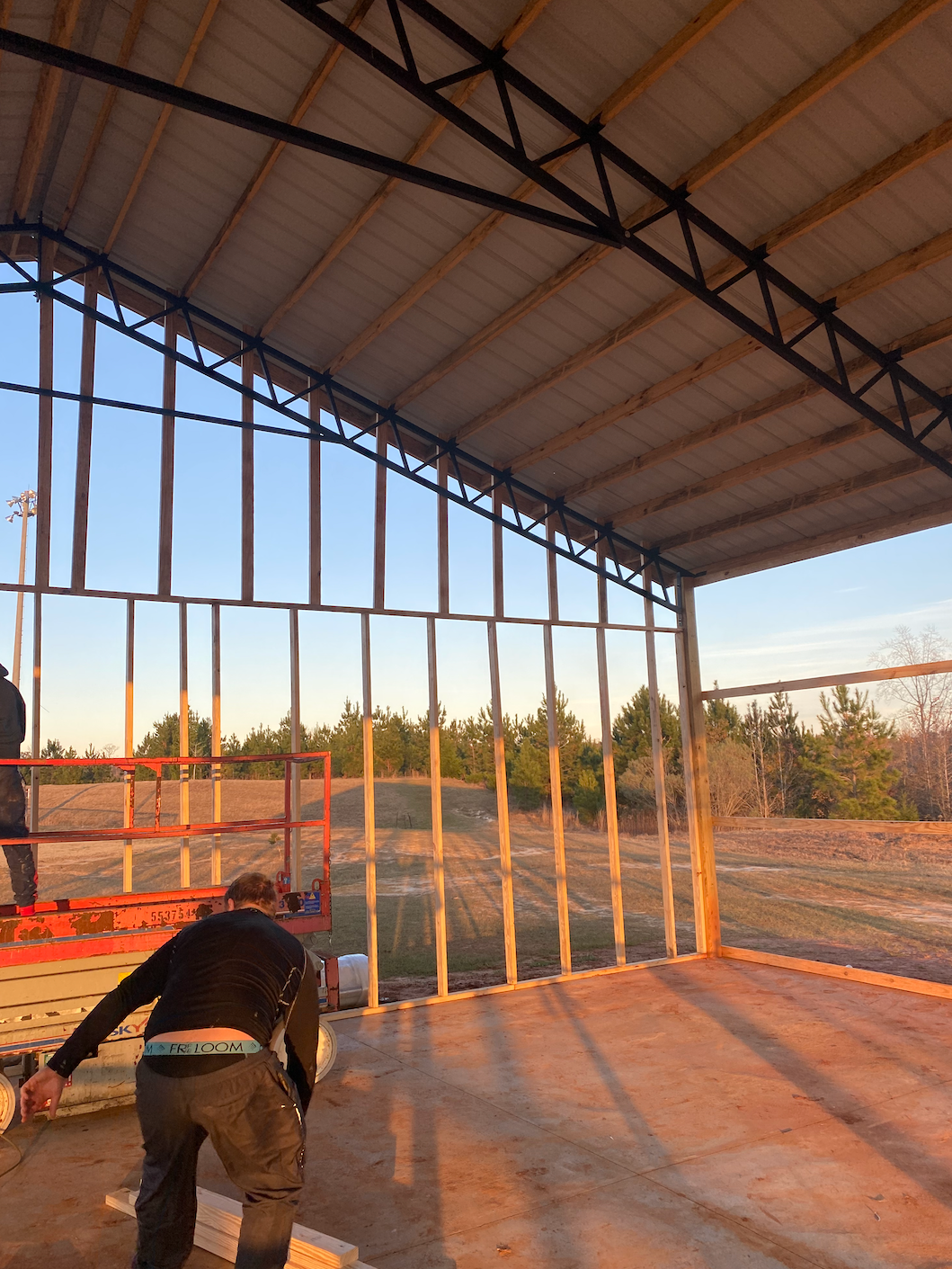 A man is standing inside of a building under construction.