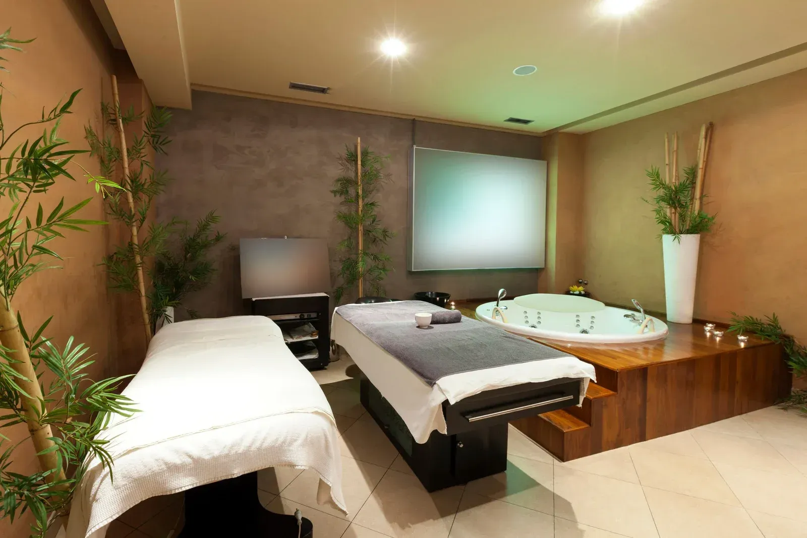 There are two massage tables and a jacuzzi in the room.
