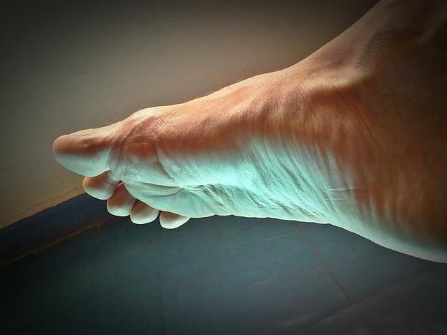 A close up of a person 's foot on a table.