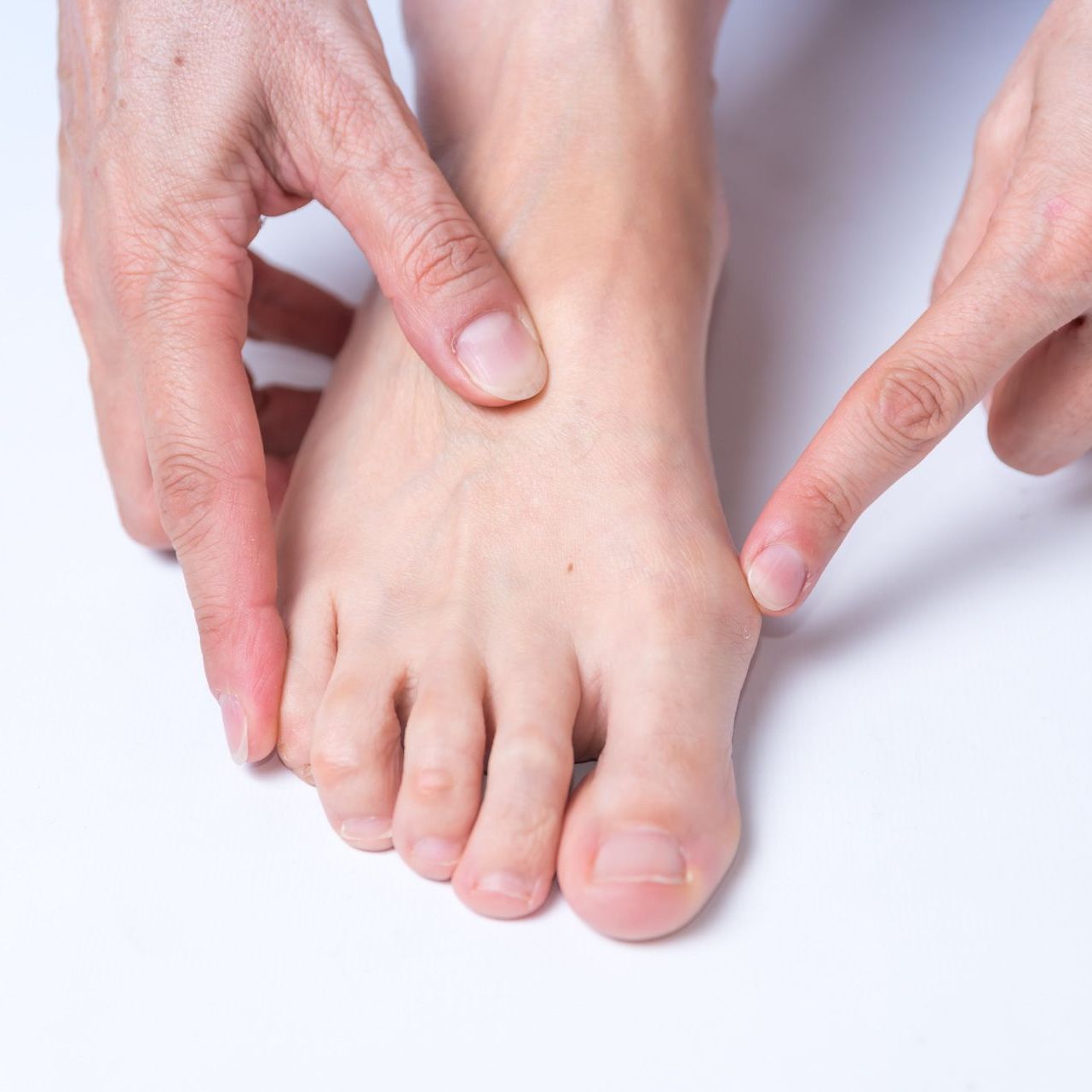 A close up of a person 's foot with a red toe.