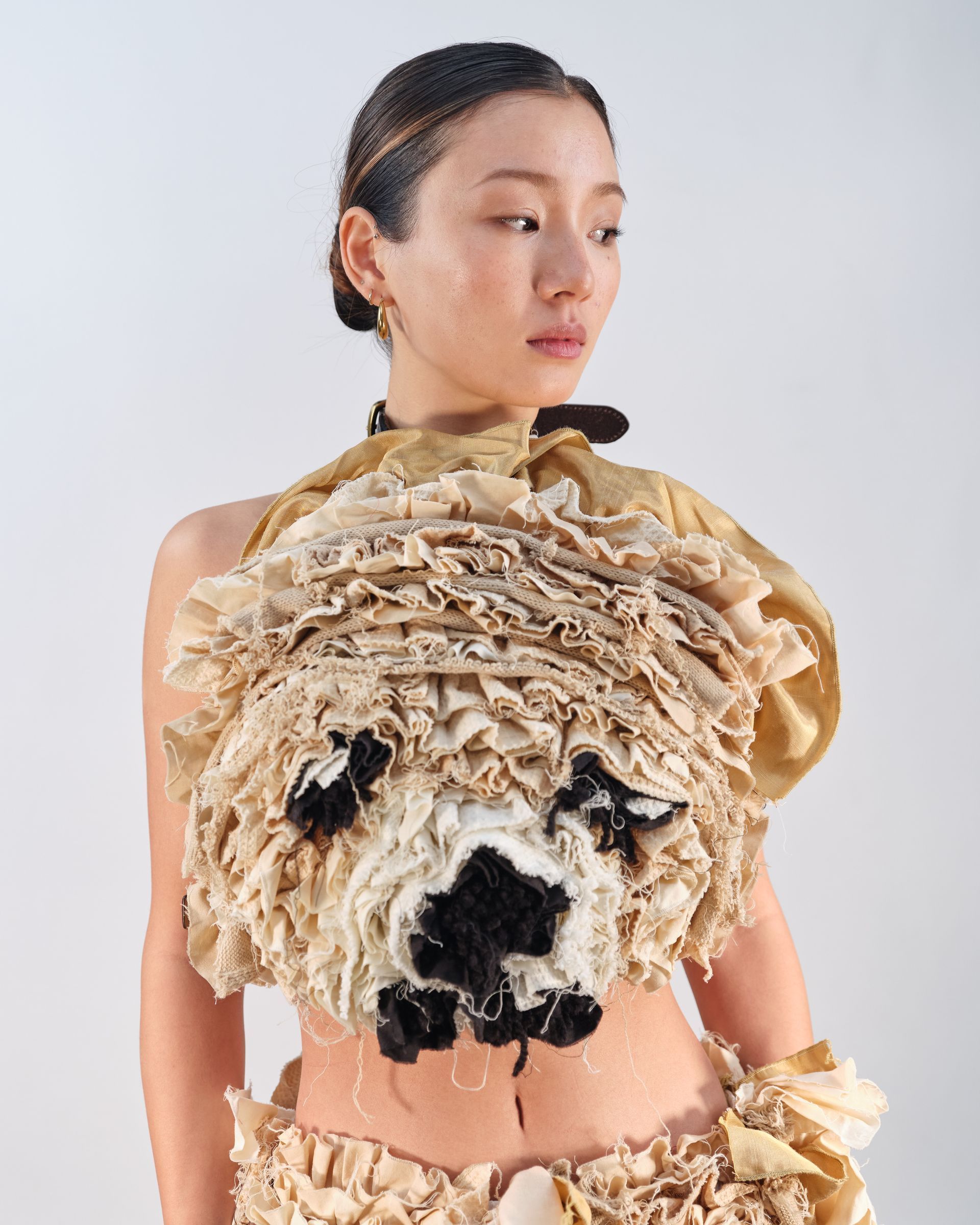 A woman is wearing a crop top with a dog face on it.