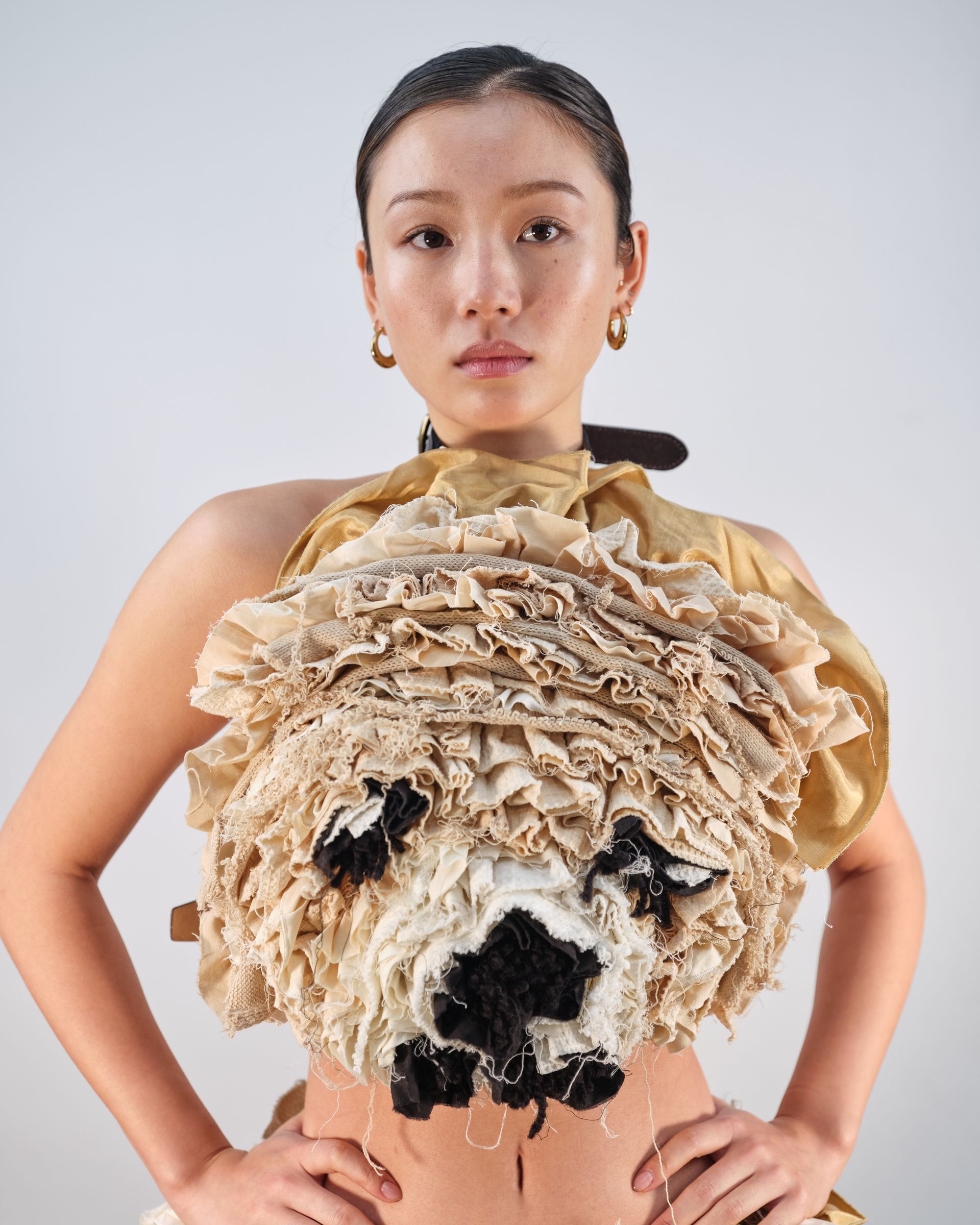 A woman is wearing a top with a dog face on it