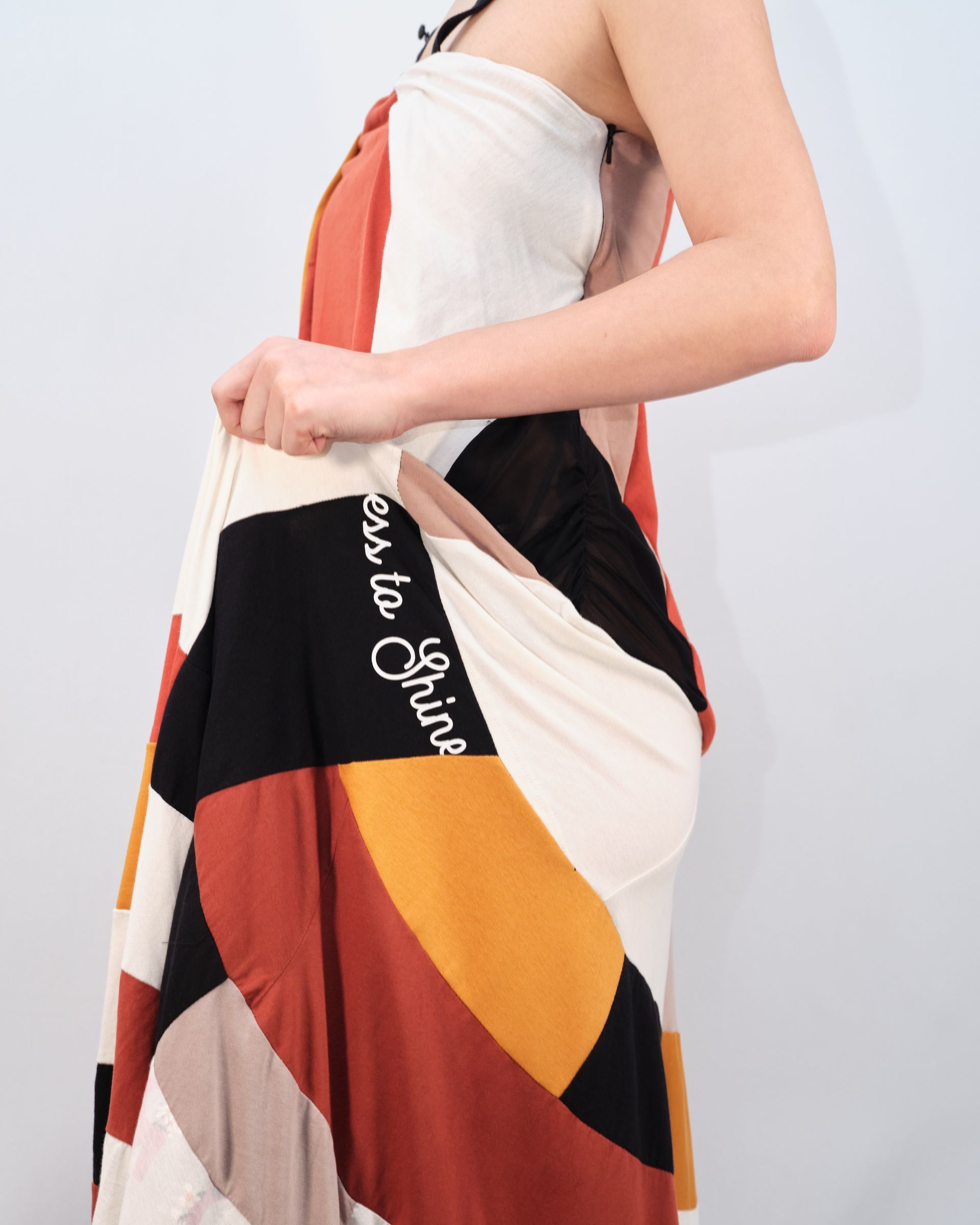 A woman is wearing a dress that says love to style