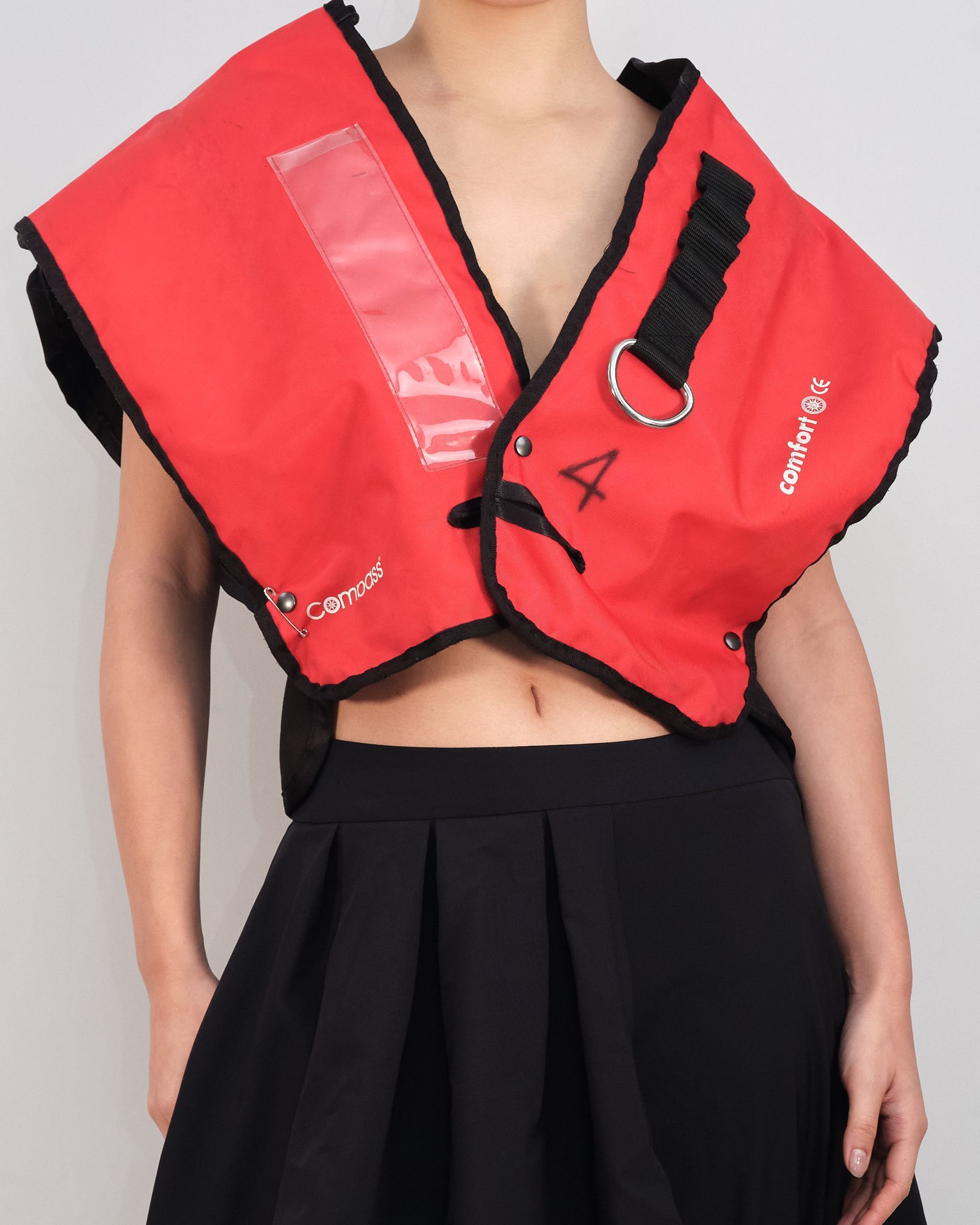 A woman wearing a red vest that says a on it