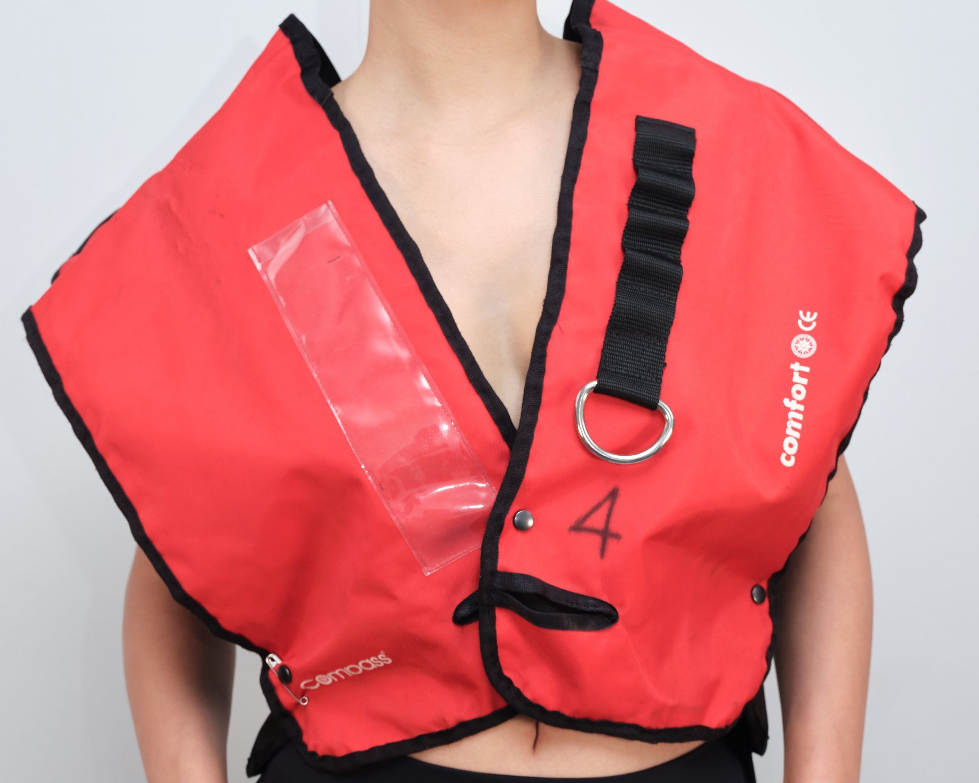 A woman wearing a red vest with the number 4 on it