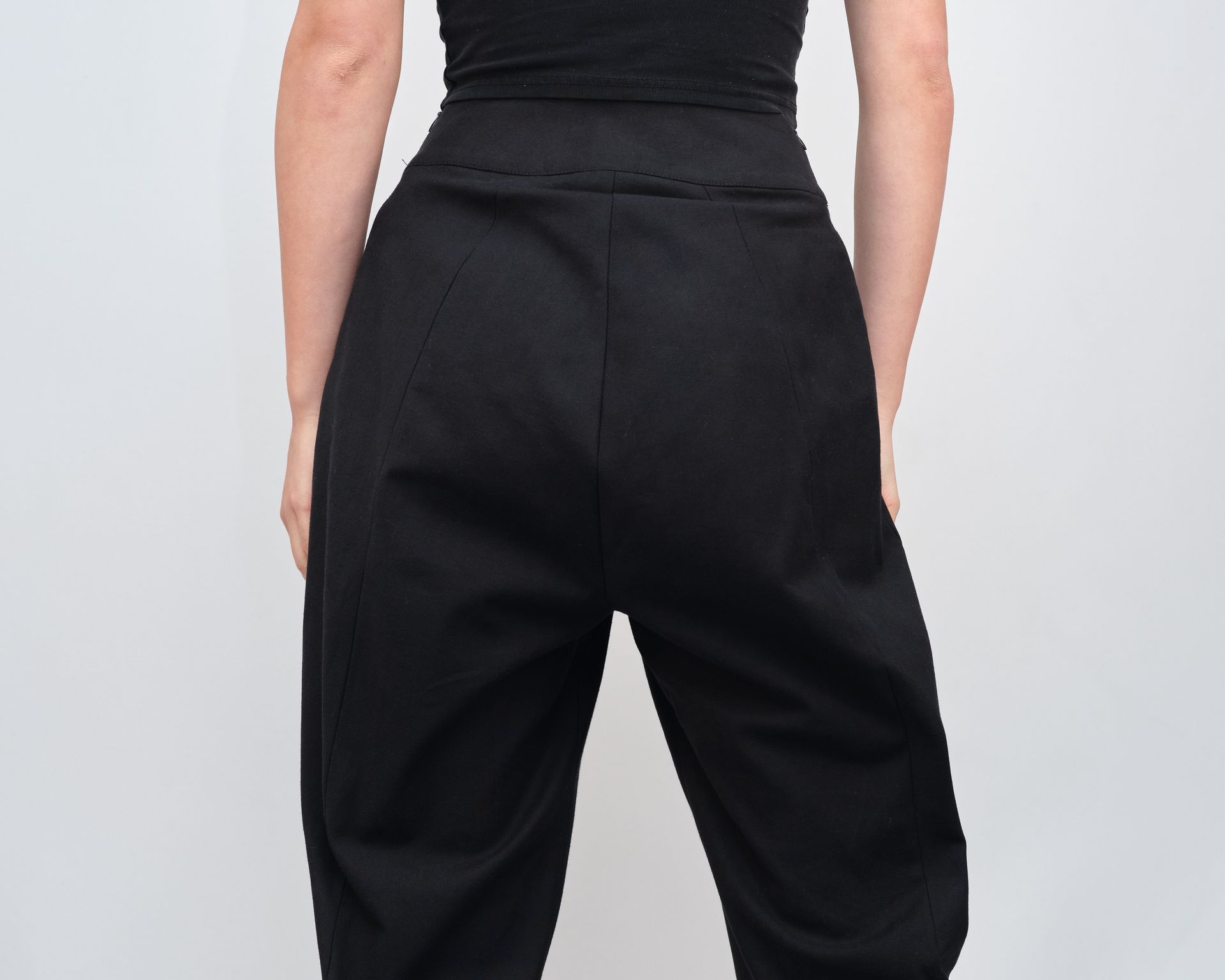 The back of a woman wearing black pants