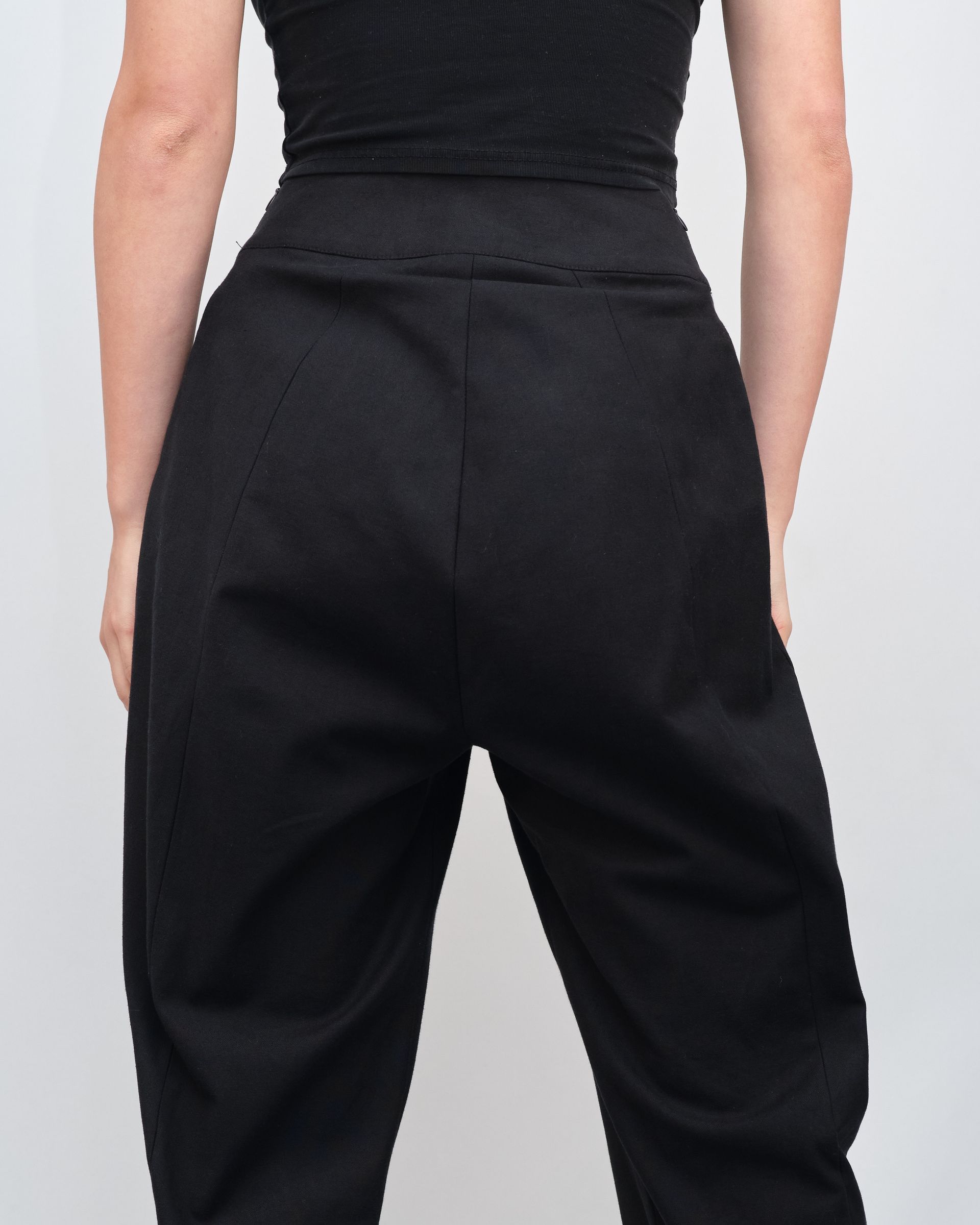 The back of a woman wearing black pants and a black top