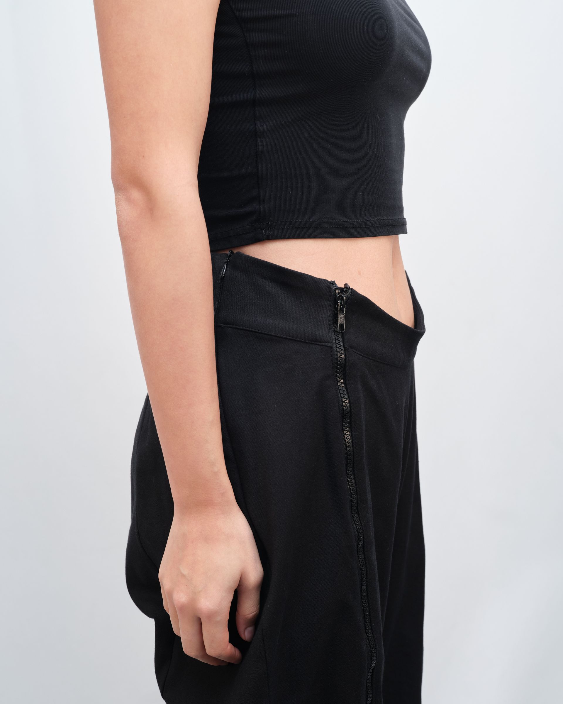 A woman is wearing a black strapless dress