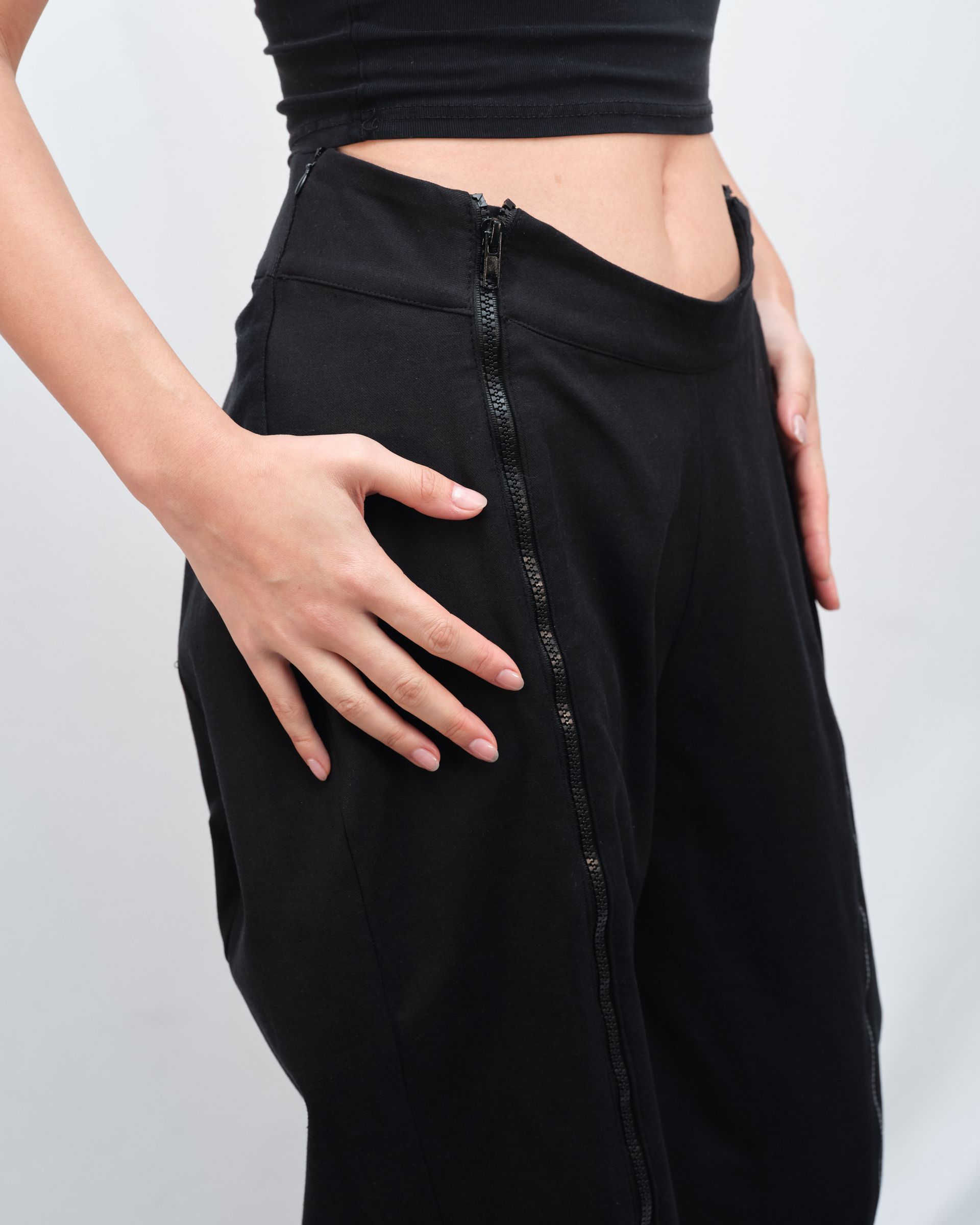 The back of a woman wearing black pants