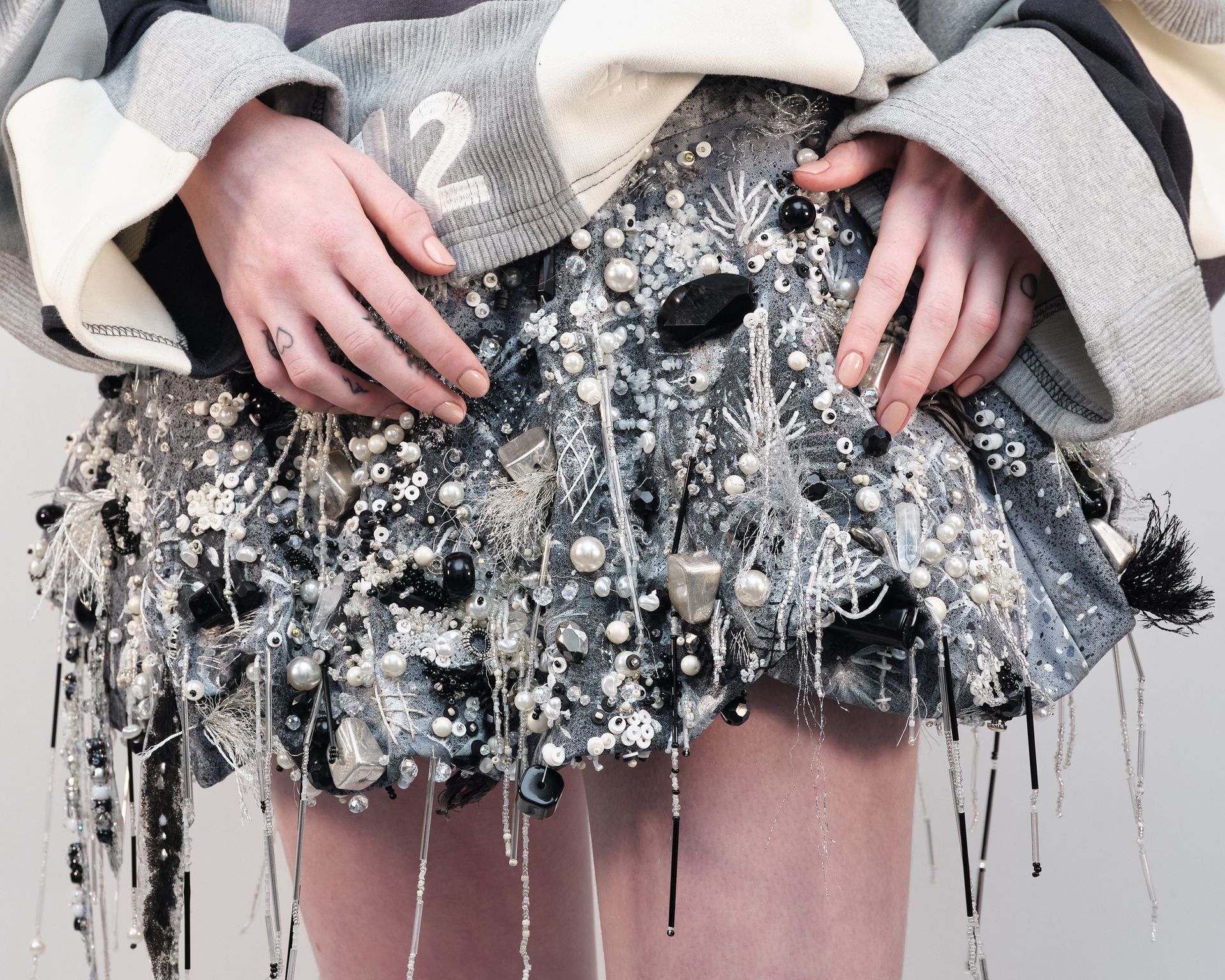 A person wearing a sweater with the number 2 on it