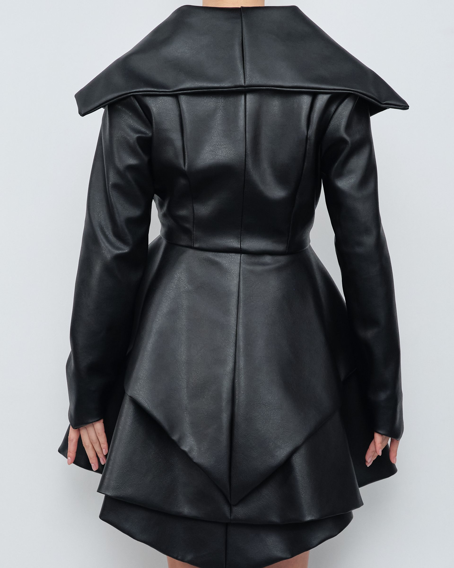 The back of a woman wearing a black leather coat
