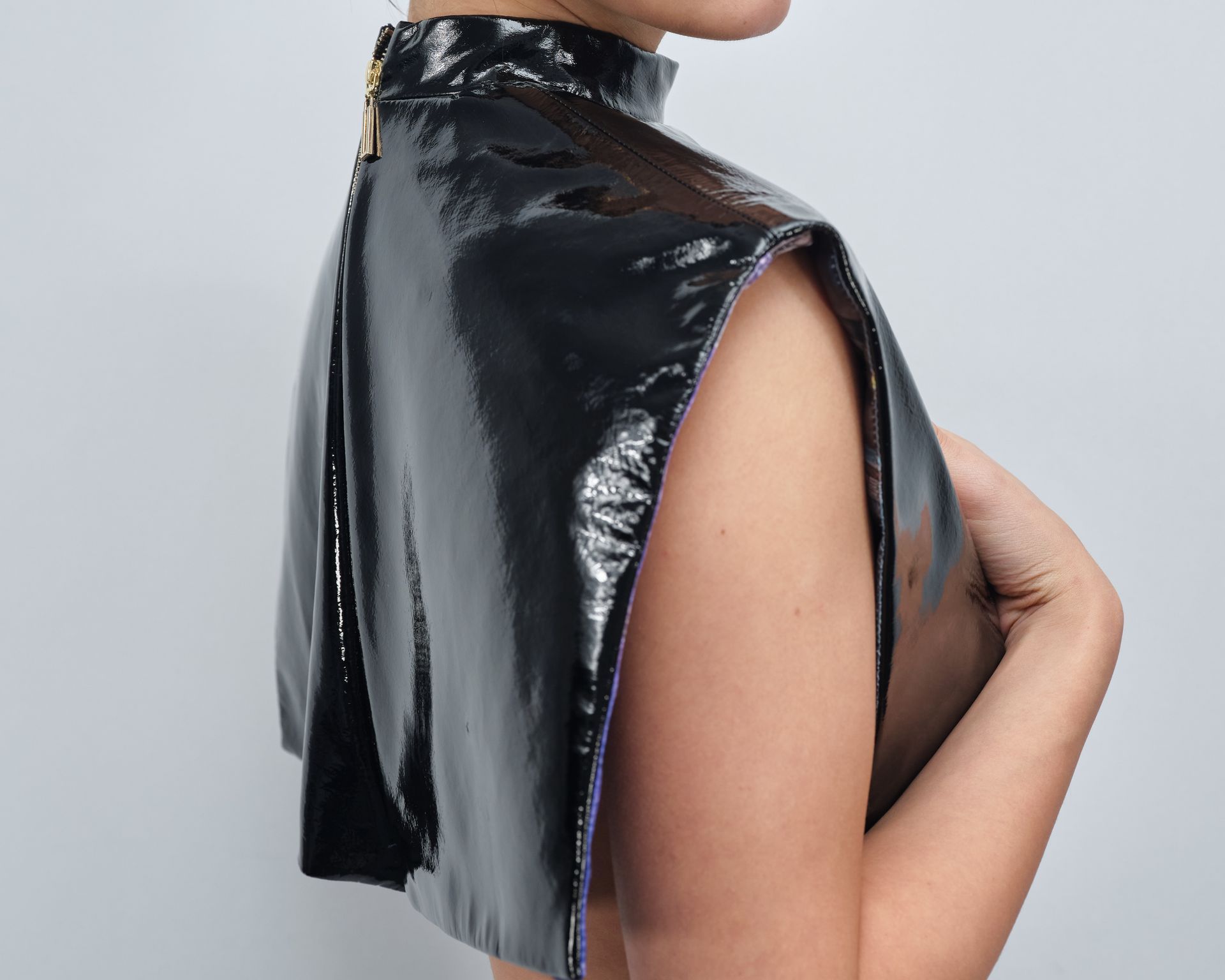 The back of a woman wearing a black cape