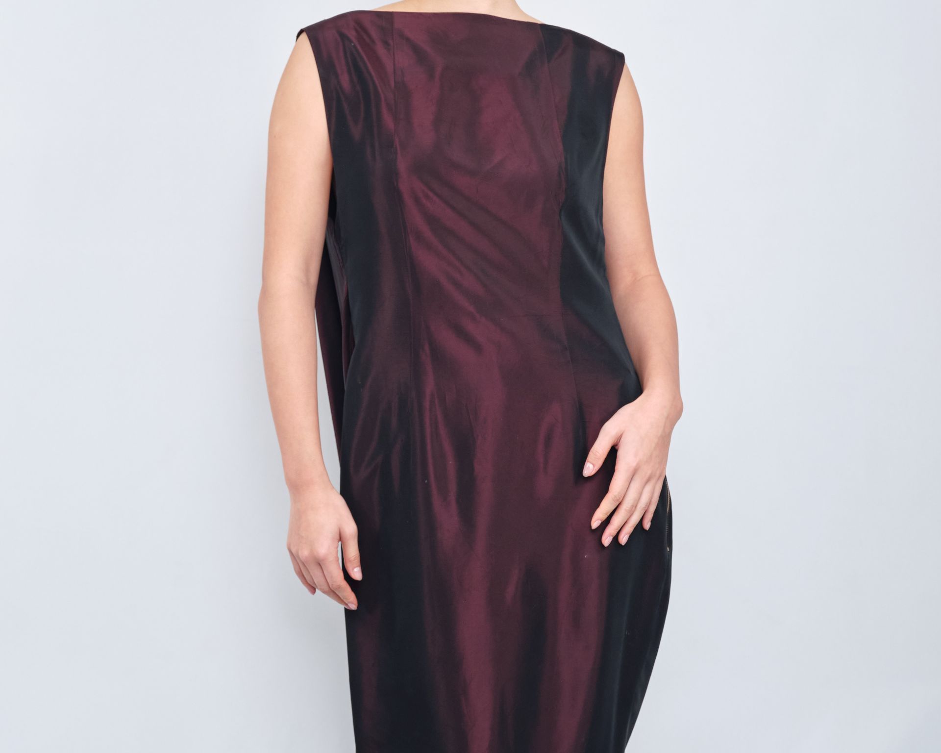 A woman is wearing a burgundy and black dress