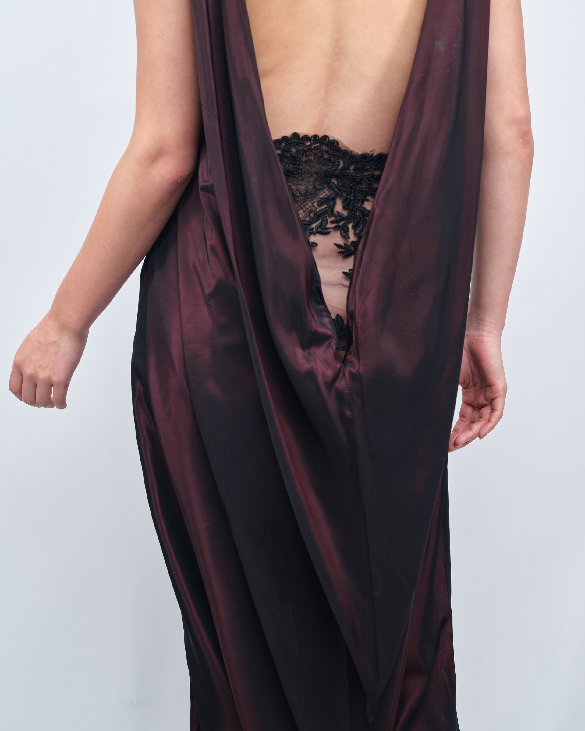 A woman is wearing a burgundy dress with a plunging neckline