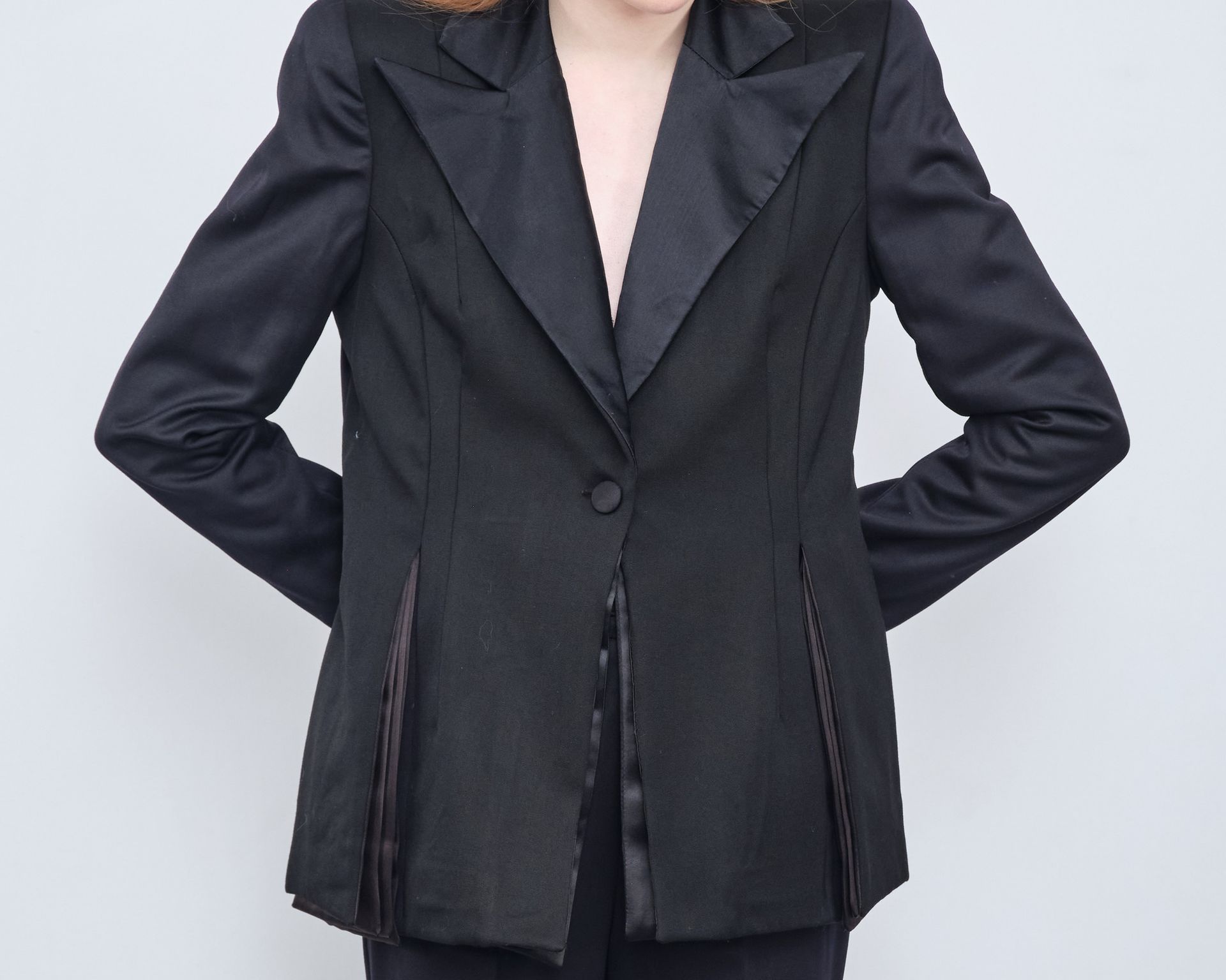 A woman is wearing a black jacket and black pants