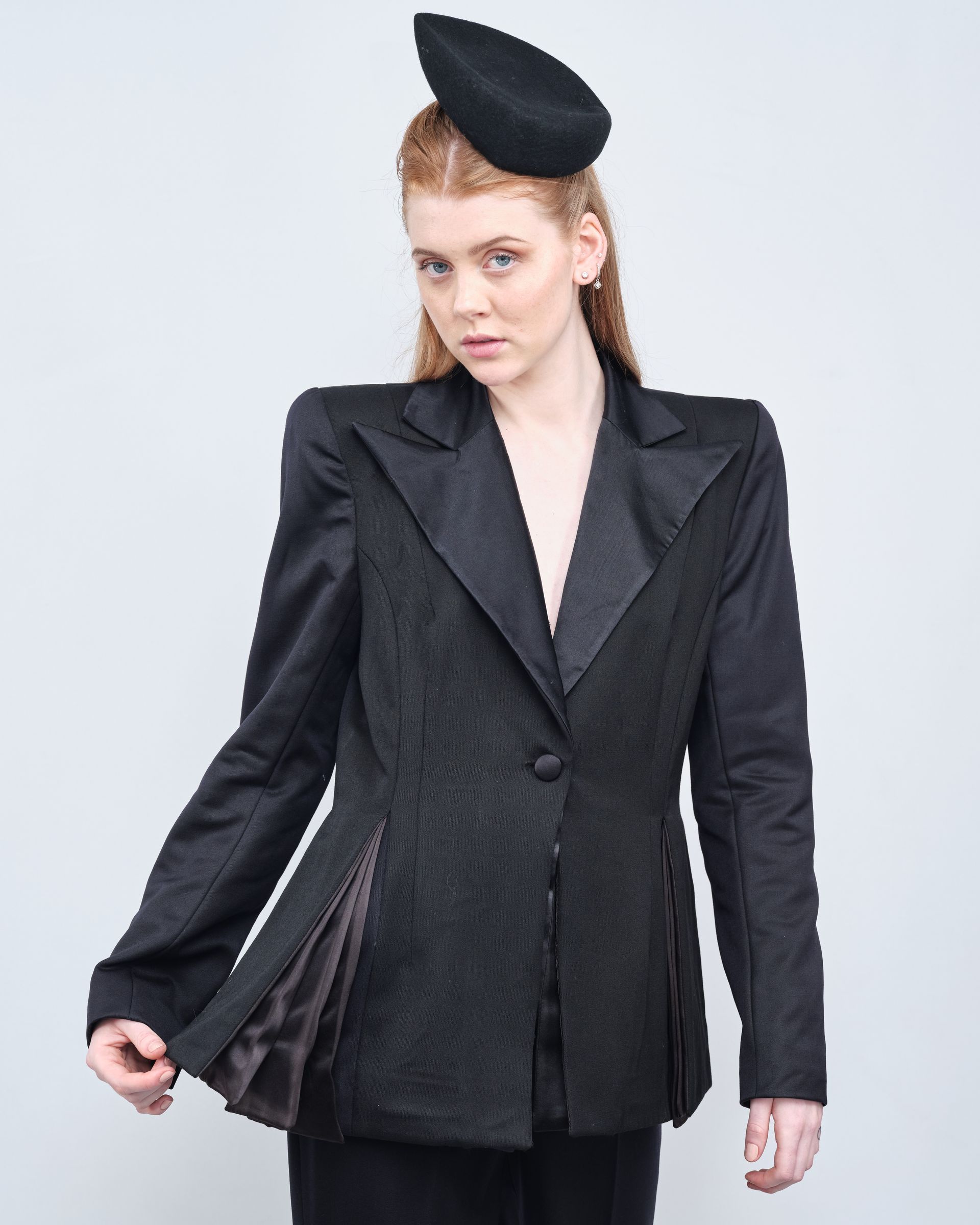 A woman wearing a black hat and a black jacket