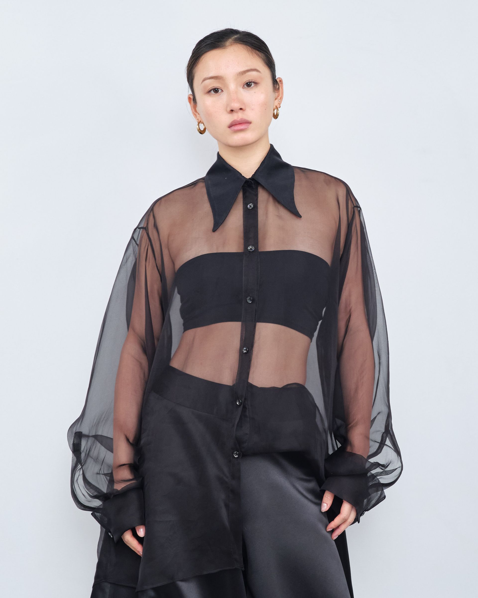 A woman is wearing a black shirt and black pants