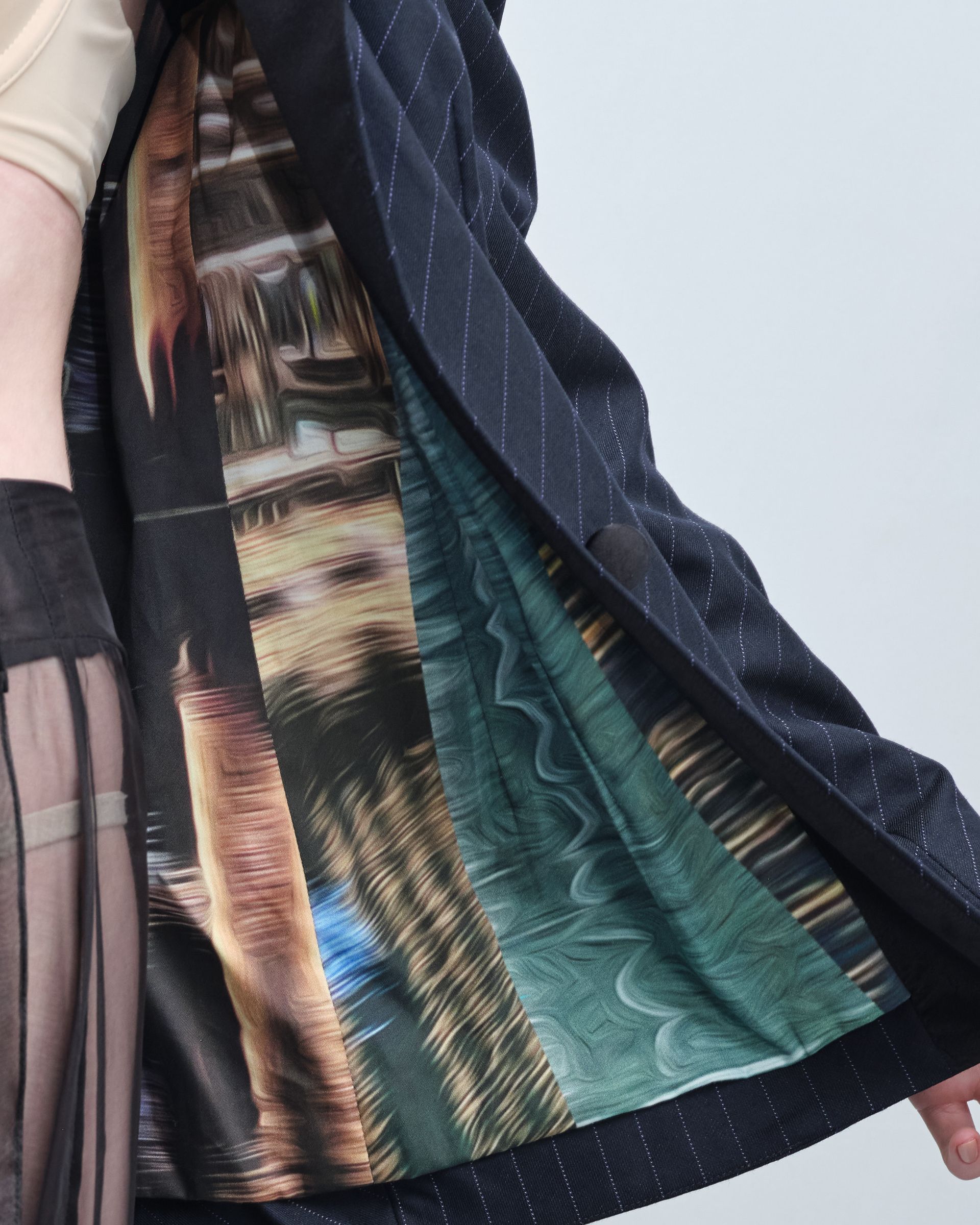 A person wearing a black jacket with a picture on the inside