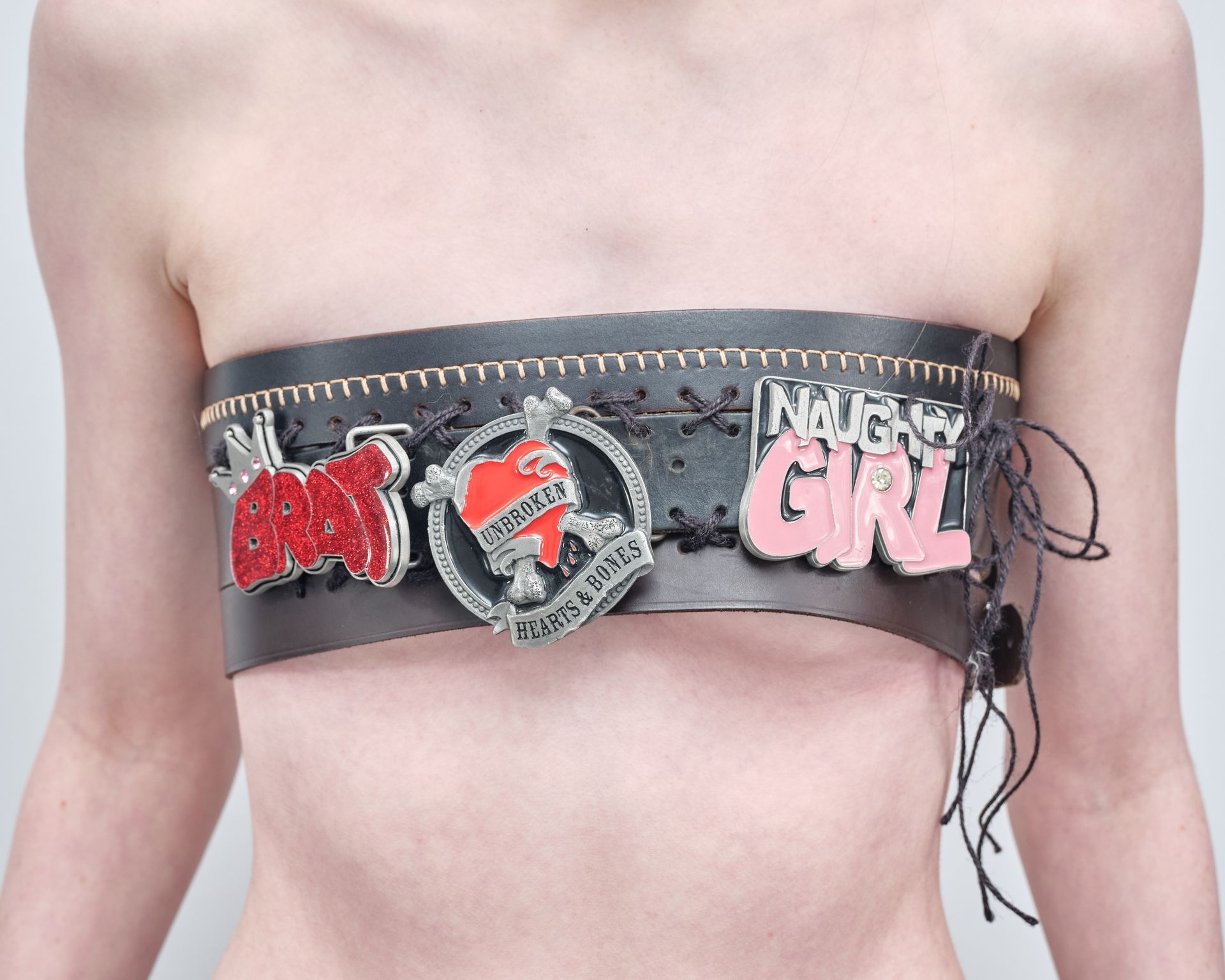 A woman is wearing a strapless top that says night girl