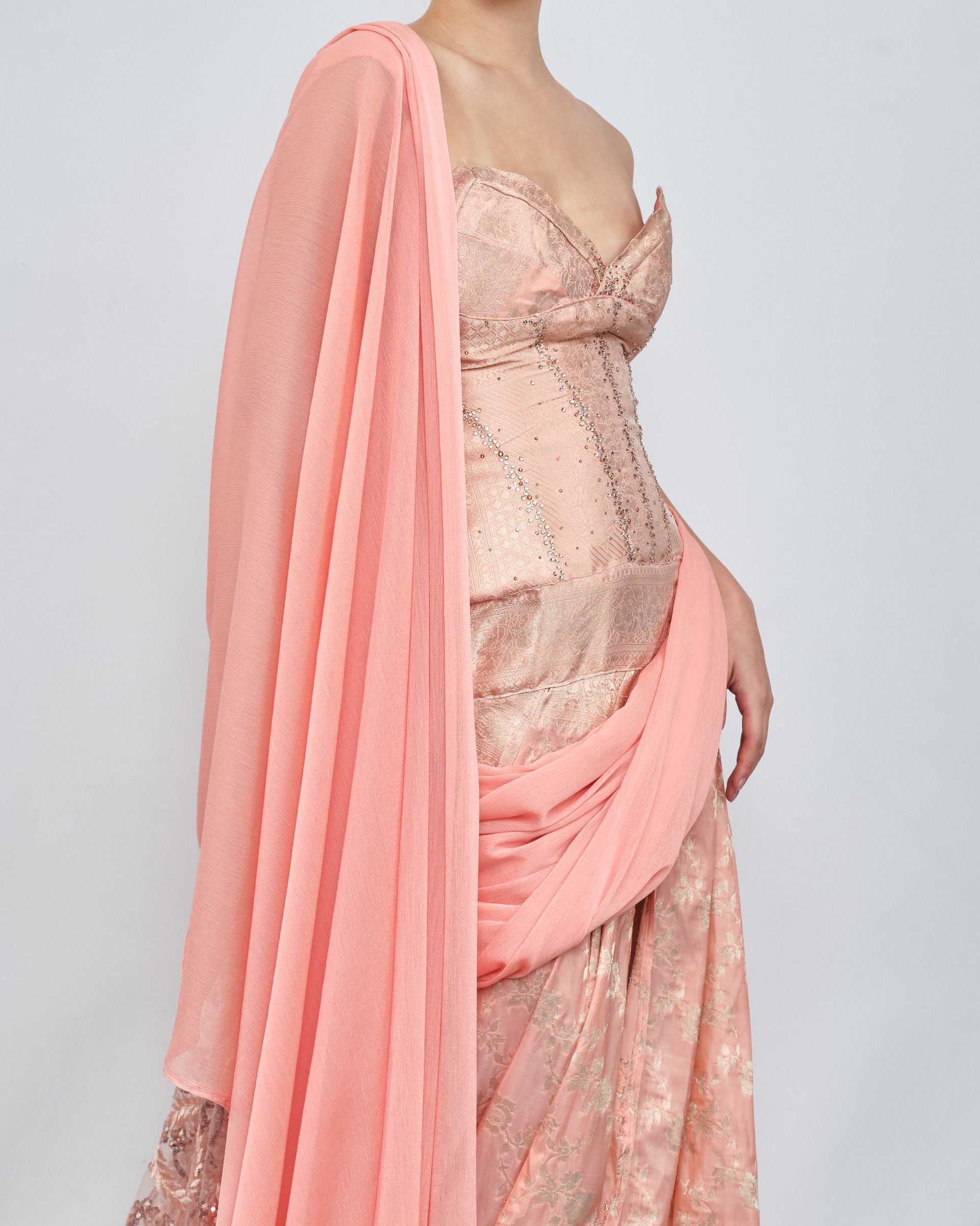 A woman is wearing a pink dress and a pink scarf.