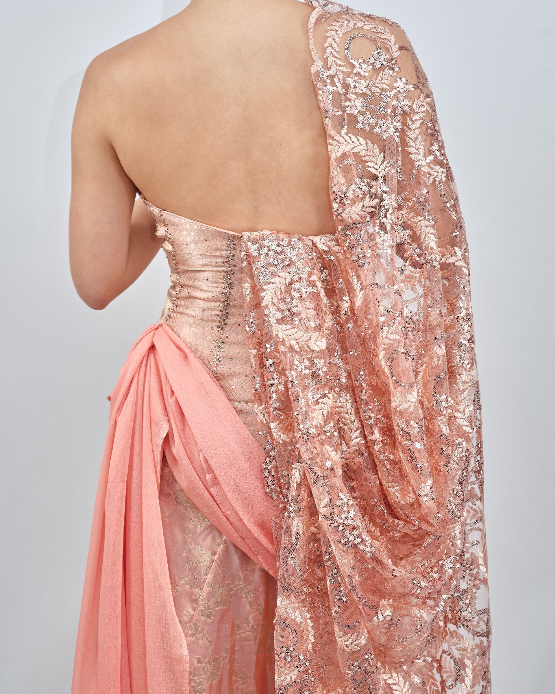 The back of a woman wearing a pink dress