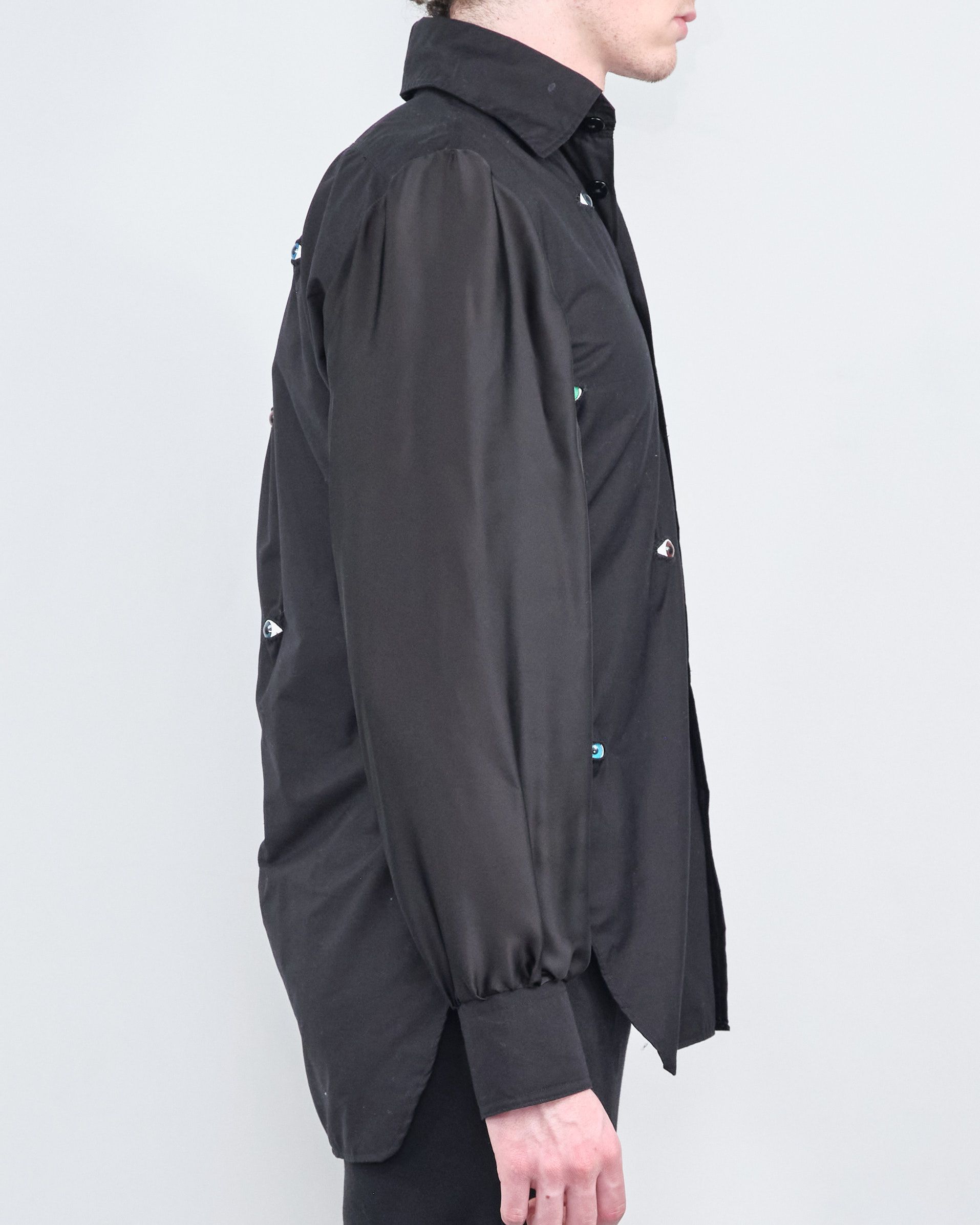 A man is wearing a black shirt and black pants.