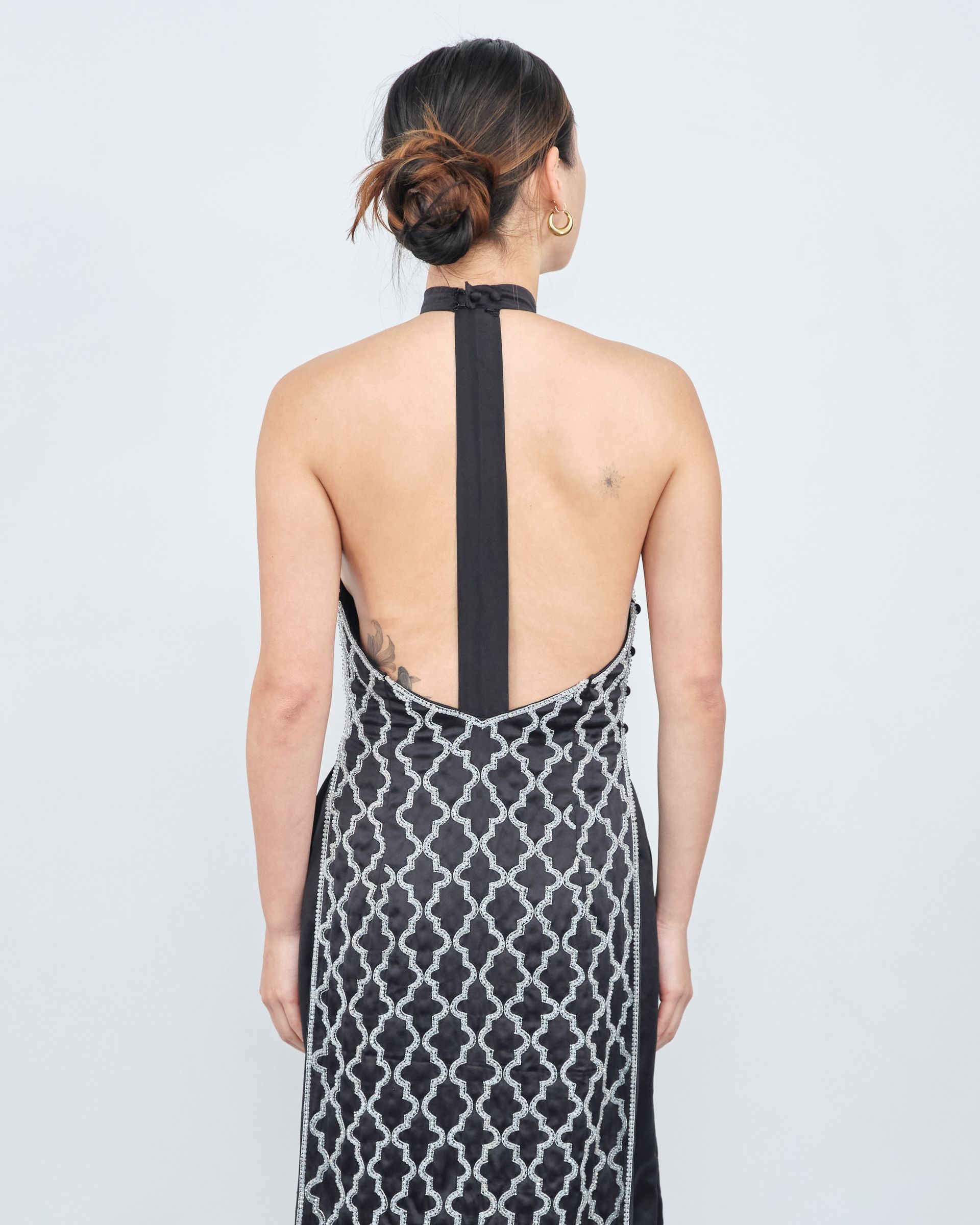 The back of a woman wearing a black and white dress