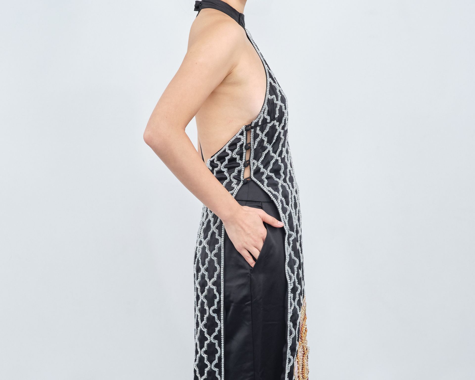 A woman is wearing a black and white halter top and black pants.