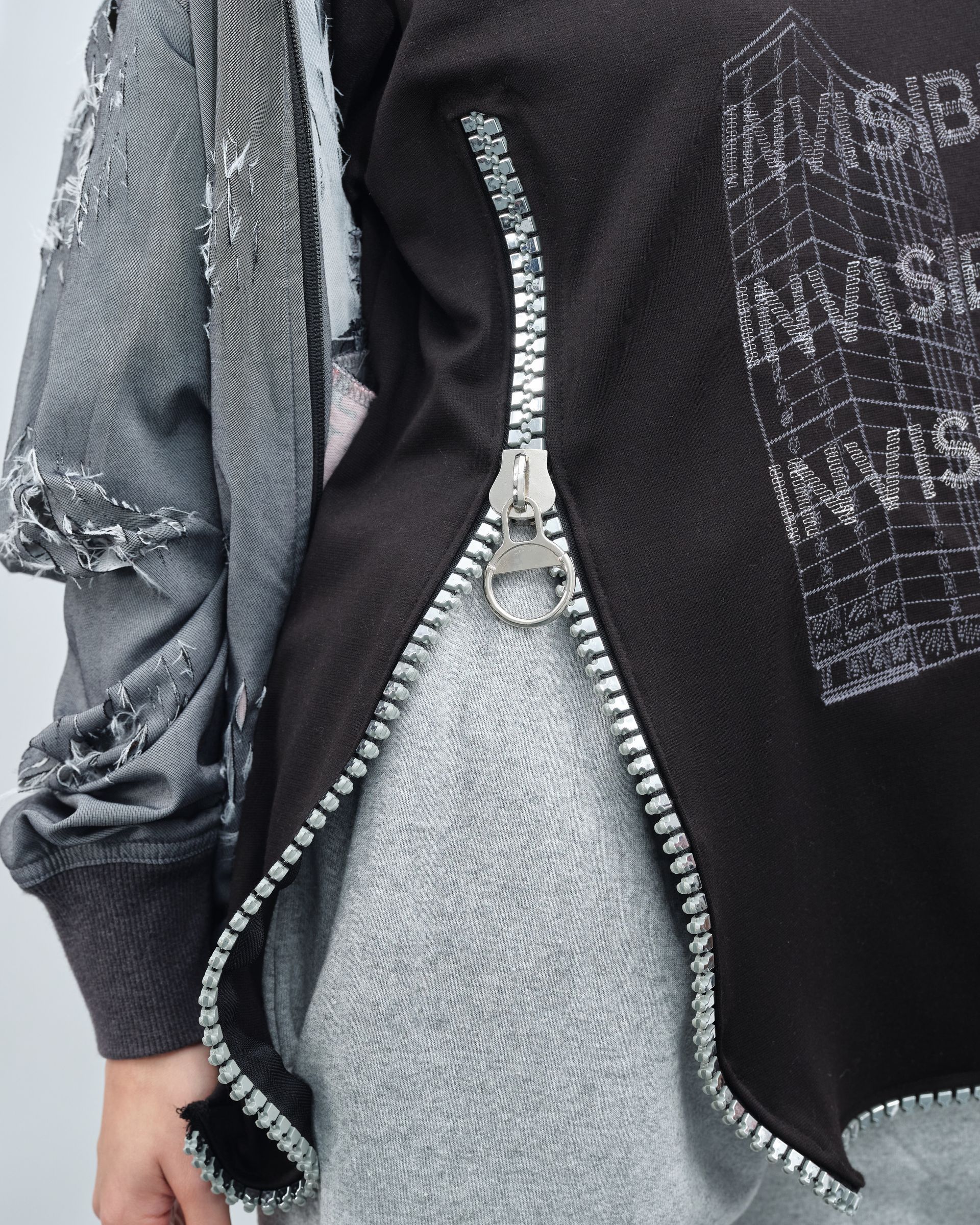 A person wearing a black shirt with the word music on it