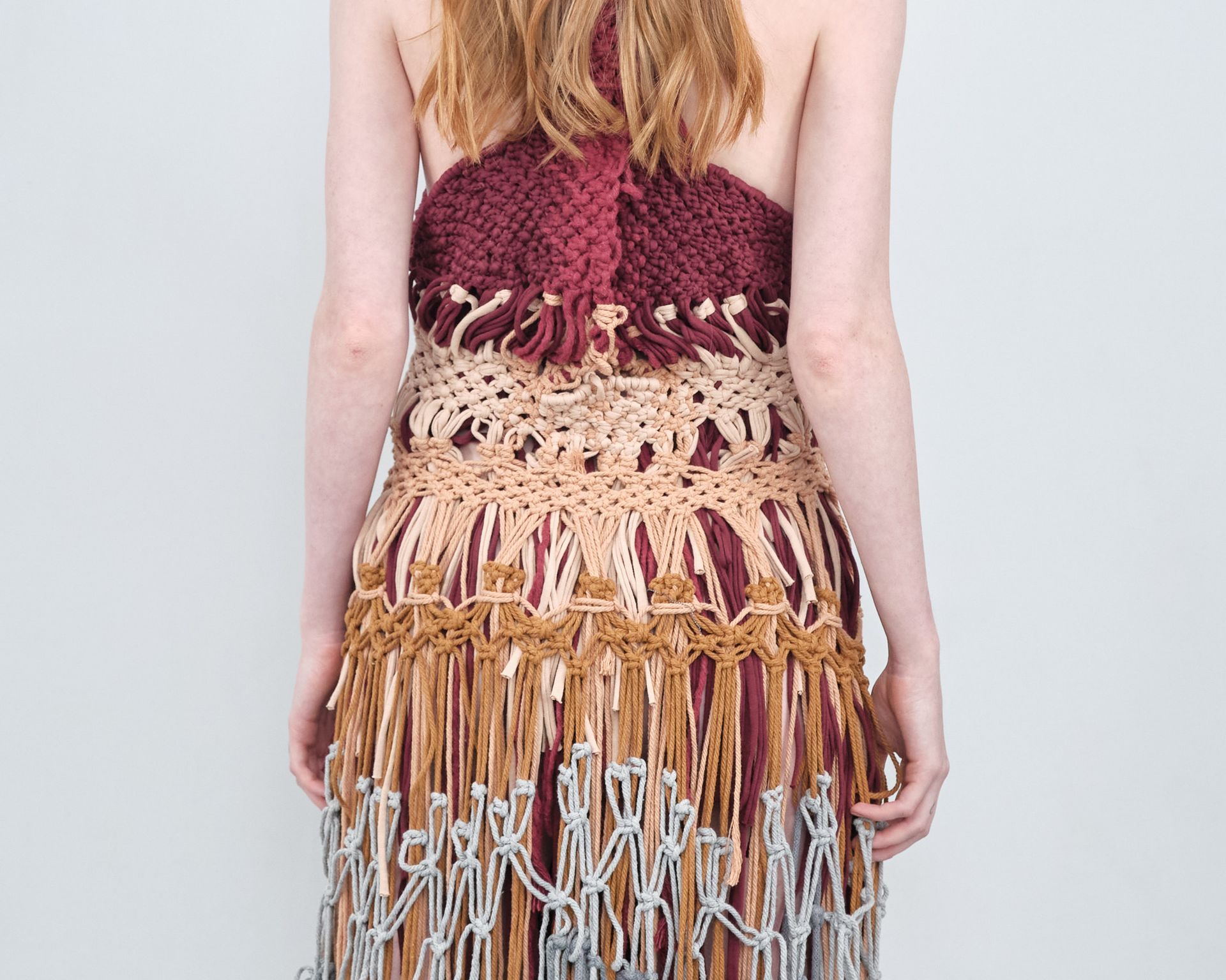 The back of a woman wearing a crocheted dress